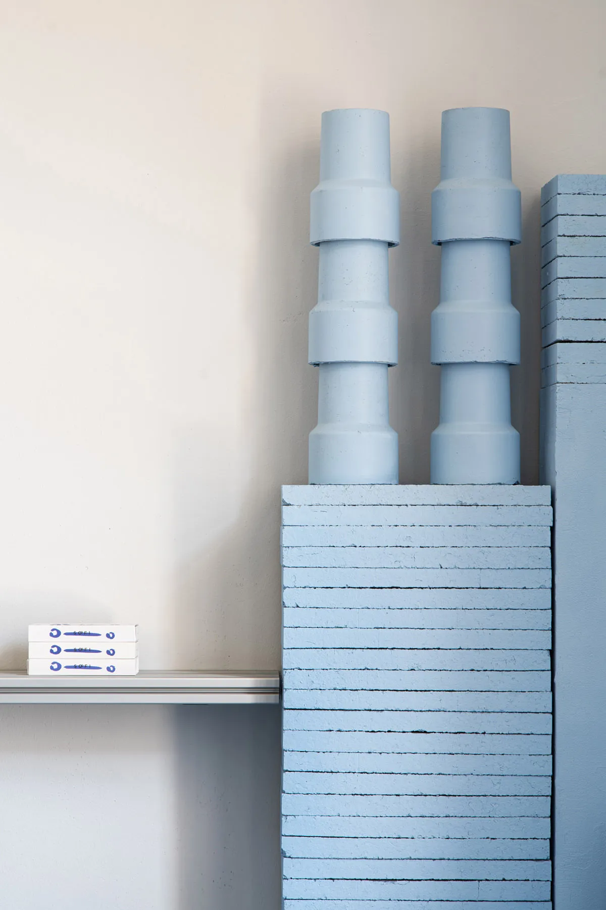 A minimalist shelf made of concrete blocks.