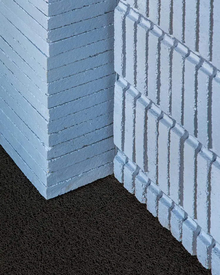 A section of a modern interior design showcasing a concrete wall and floor.