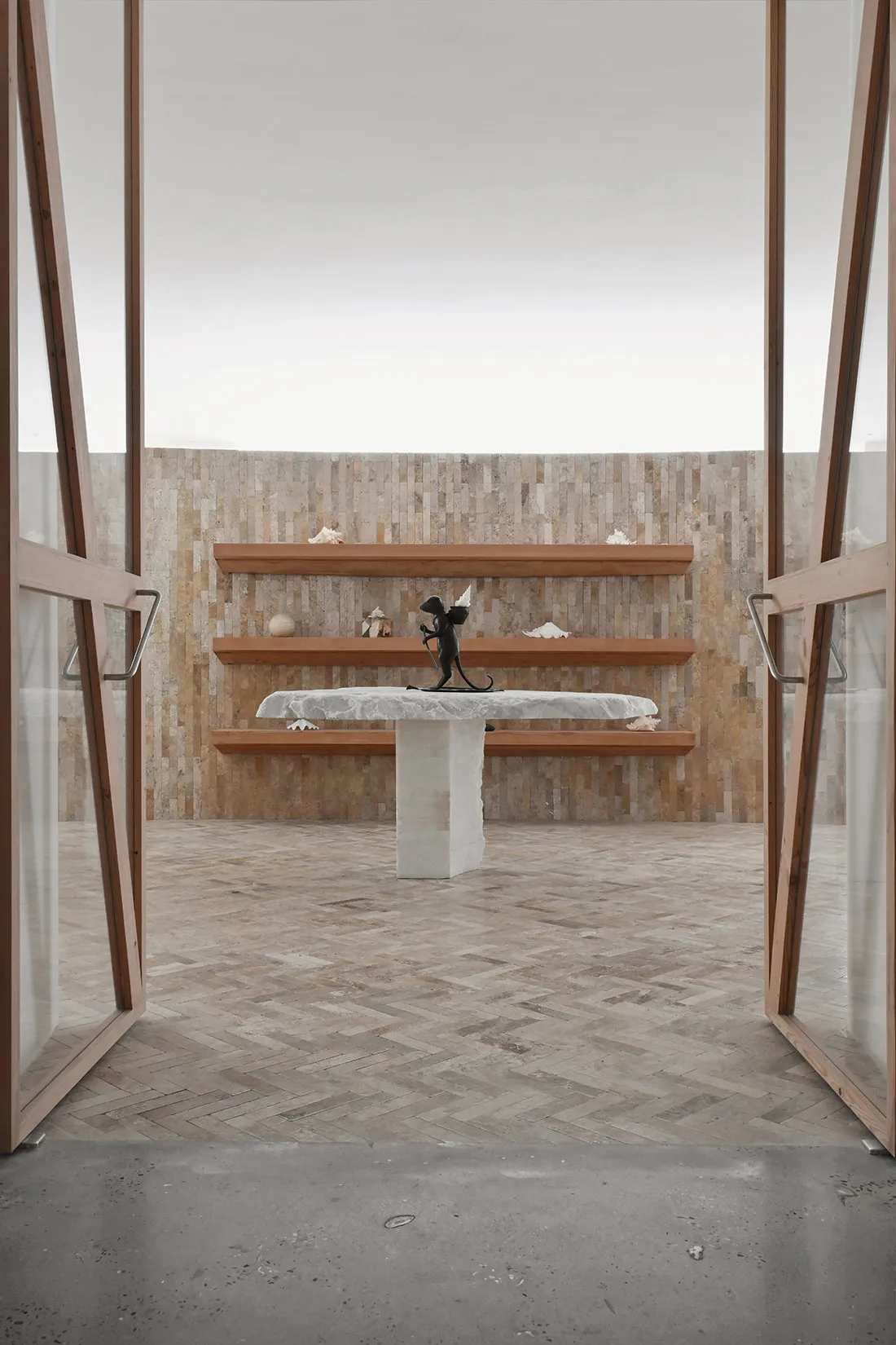 Modern art gallery with wooden shelves and a concrete table
