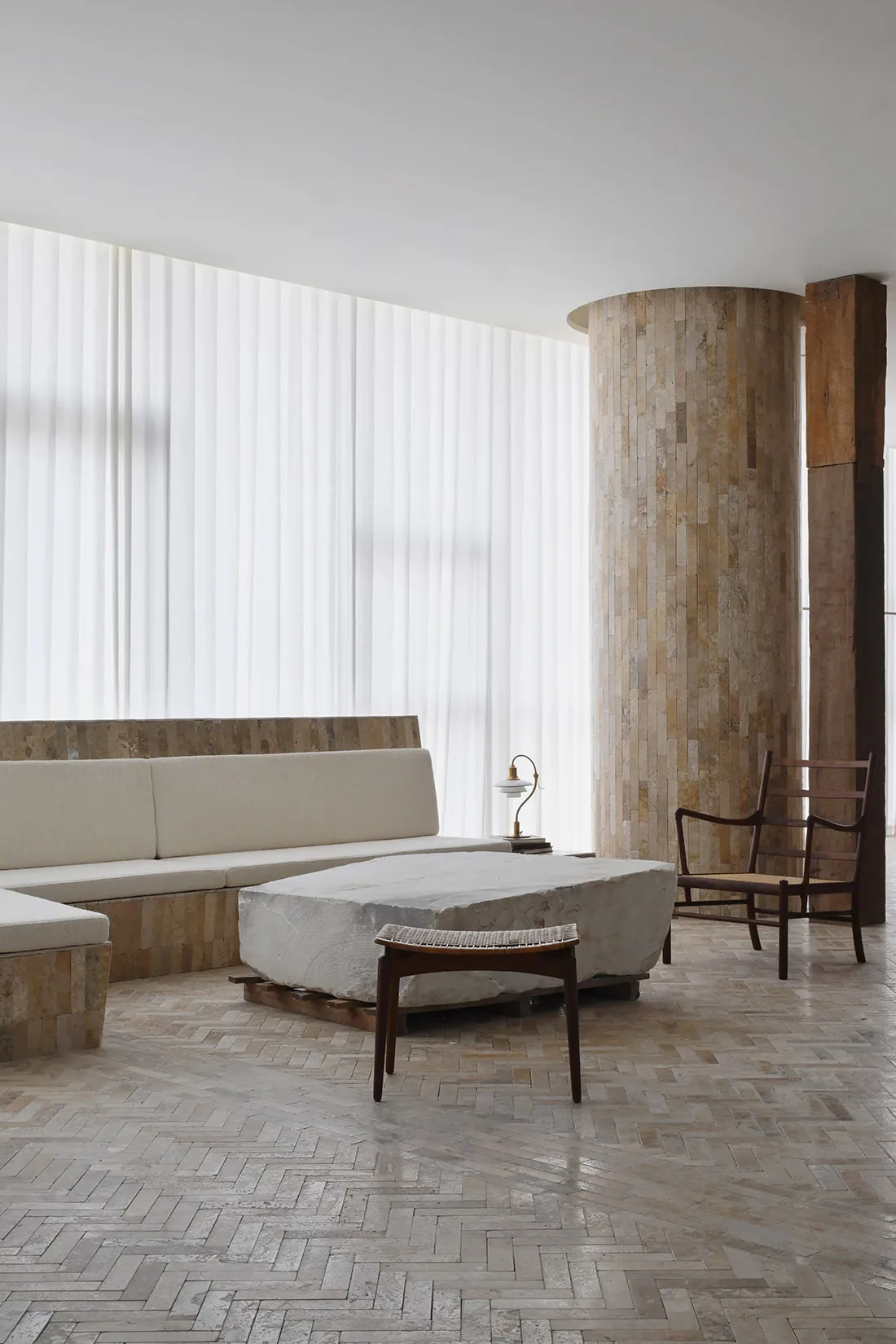 A modern living room featuring a concrete floor and minimalist design.