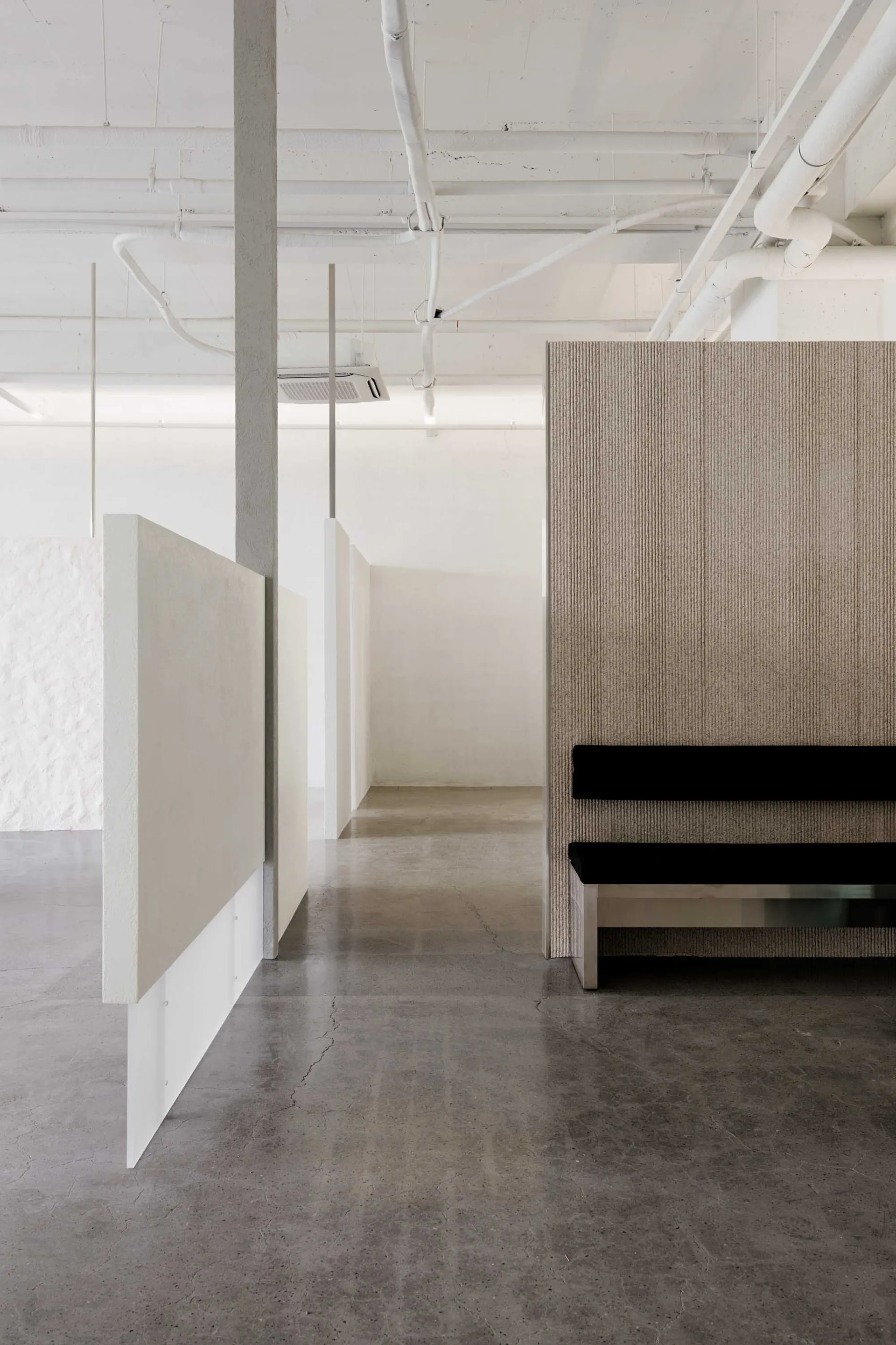 Modern office space with minimalist decor and concrete finishes.