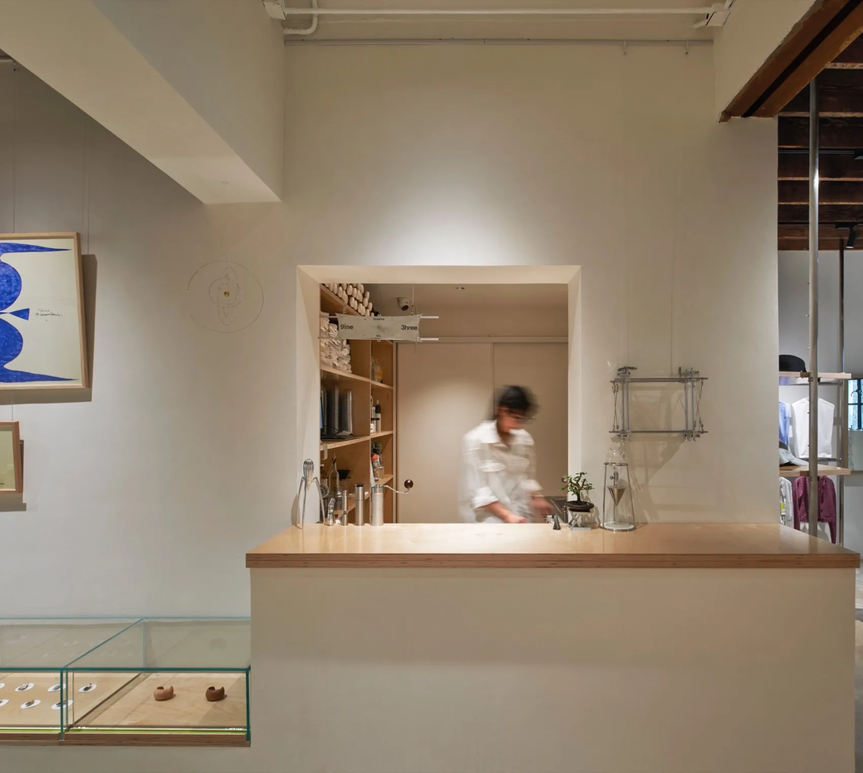 Modern retail space featuring a minimalist design with wooden panels and concrete walls