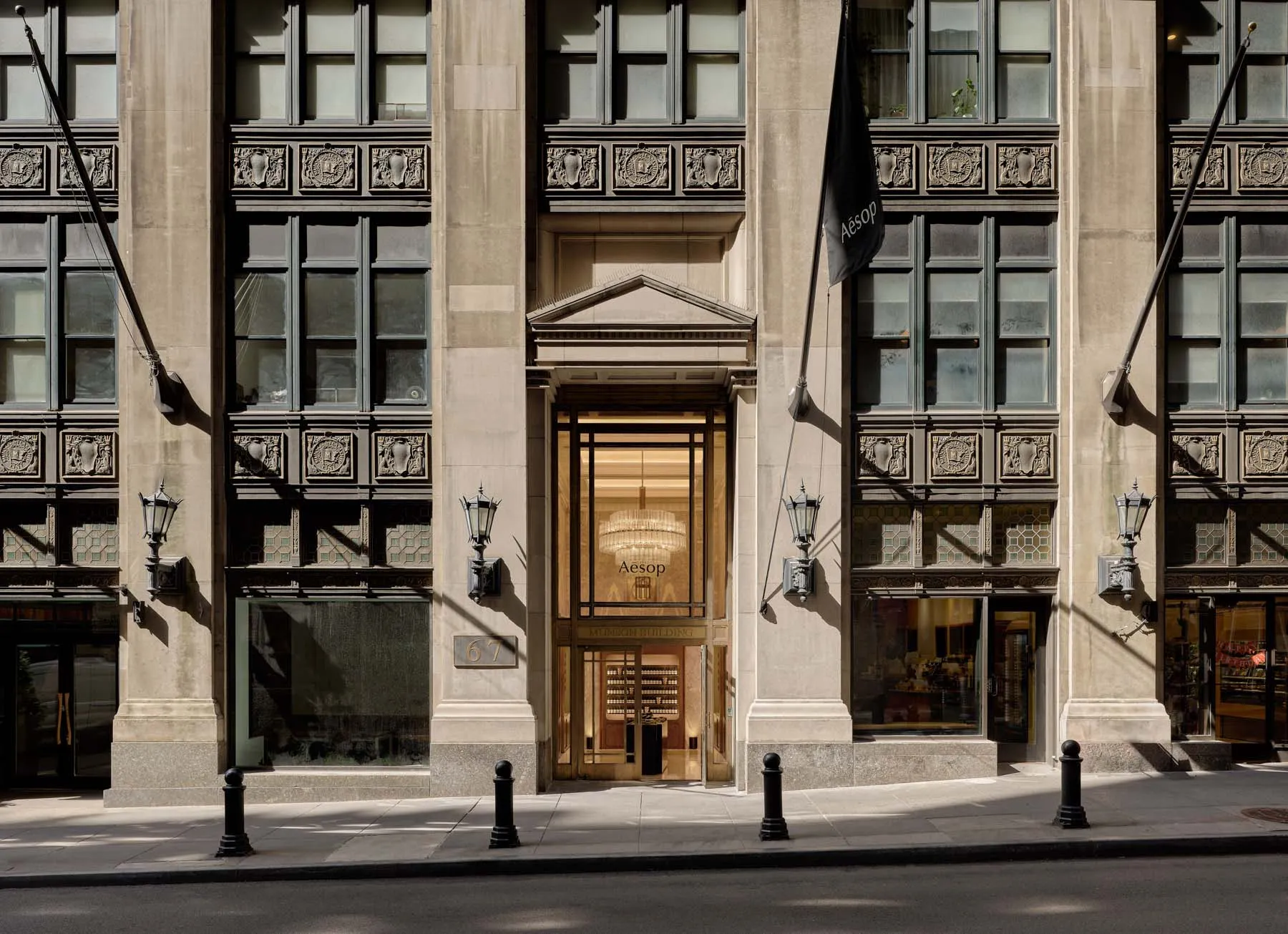 Modern retail storefront featuring glass, stone, and metal architectural elements