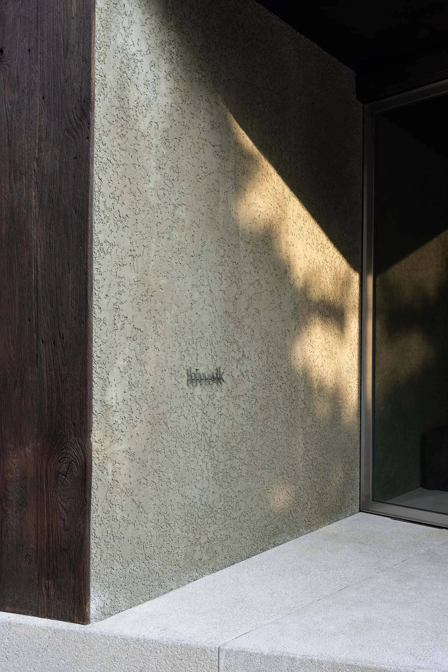 Concrete exterior wall with sunlight casting shadows