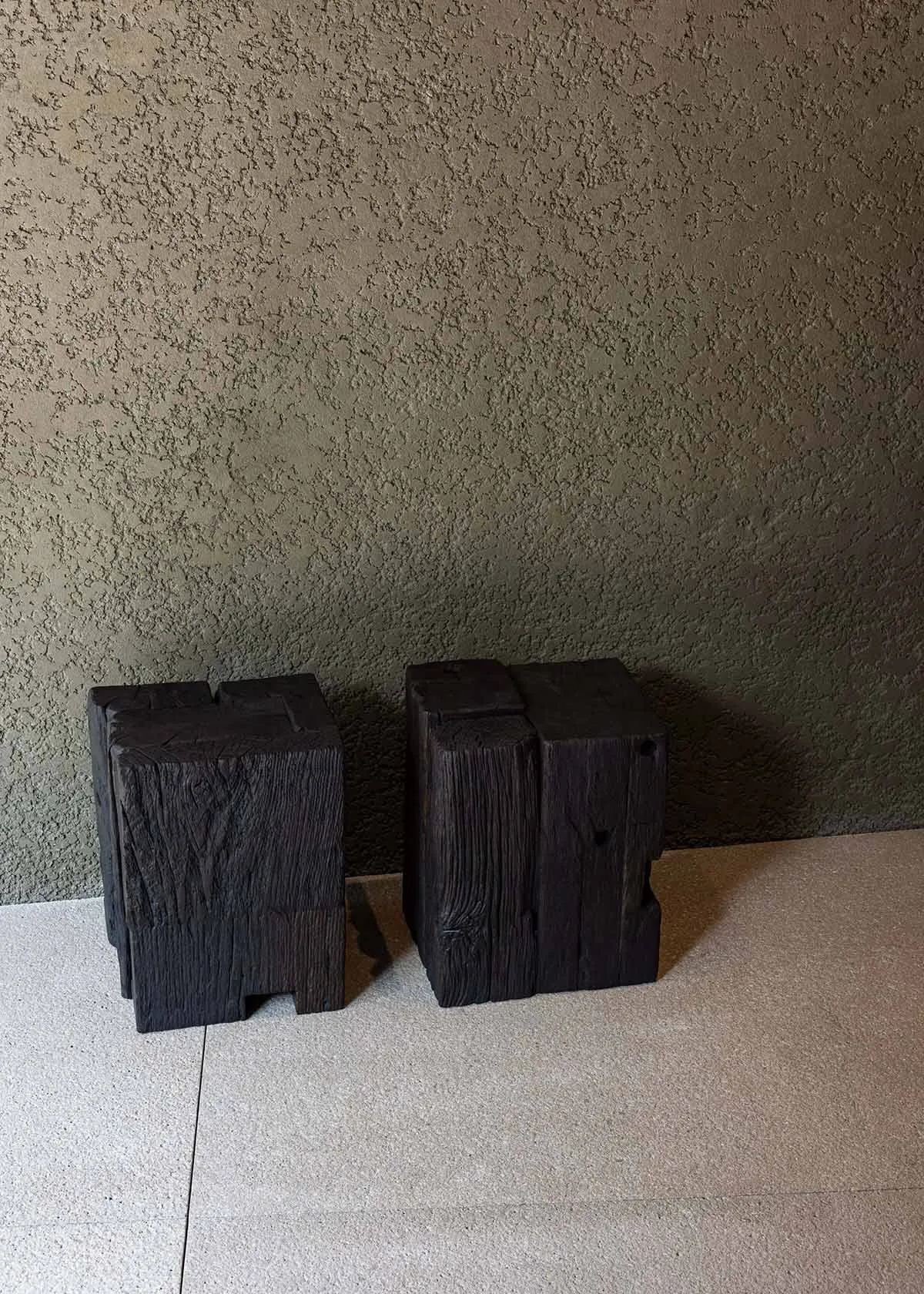 Industrial-style wooden blocks against a textured wall.