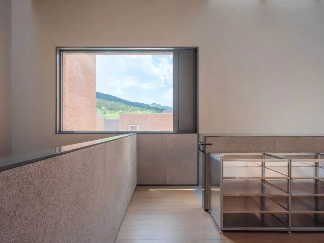 Minimalist interior featuring metal, concrete, and wood elements.