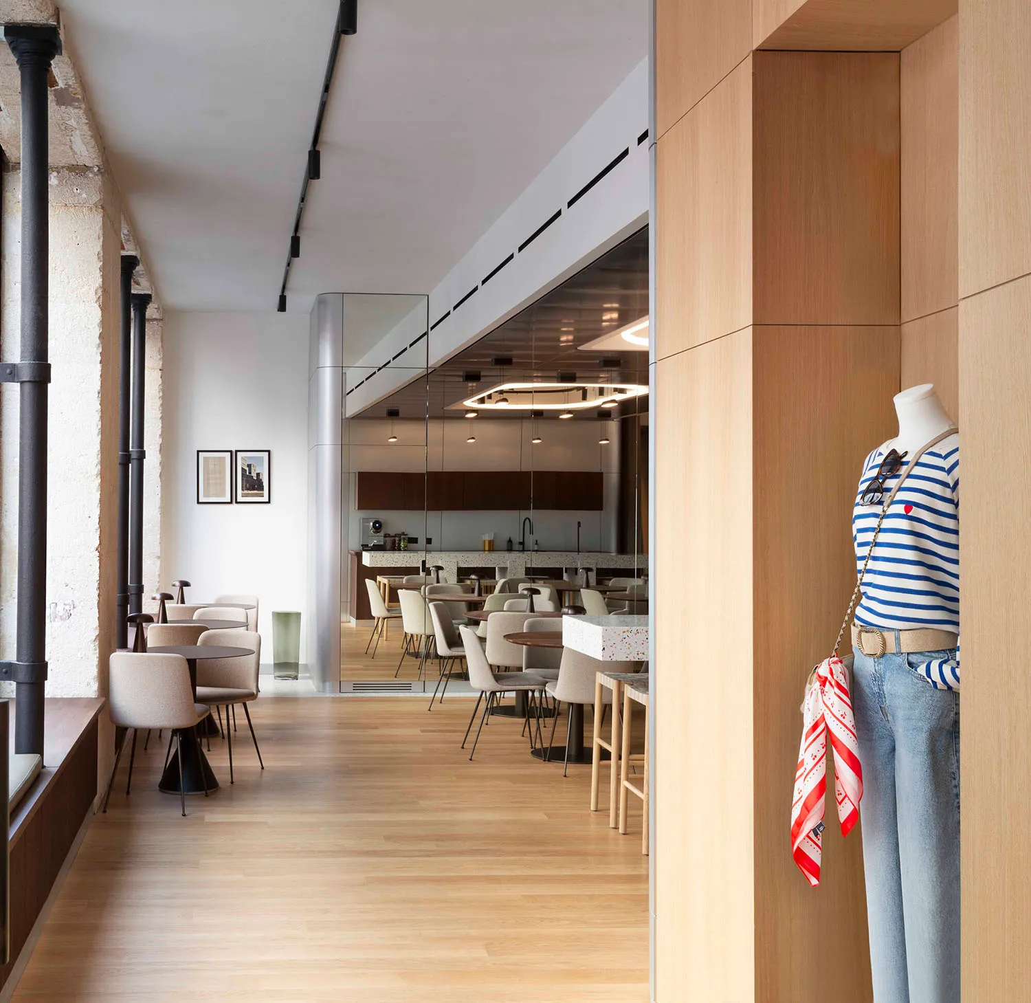 A modern cafeteria interior with wooden floors, glass walls, and metal accents.