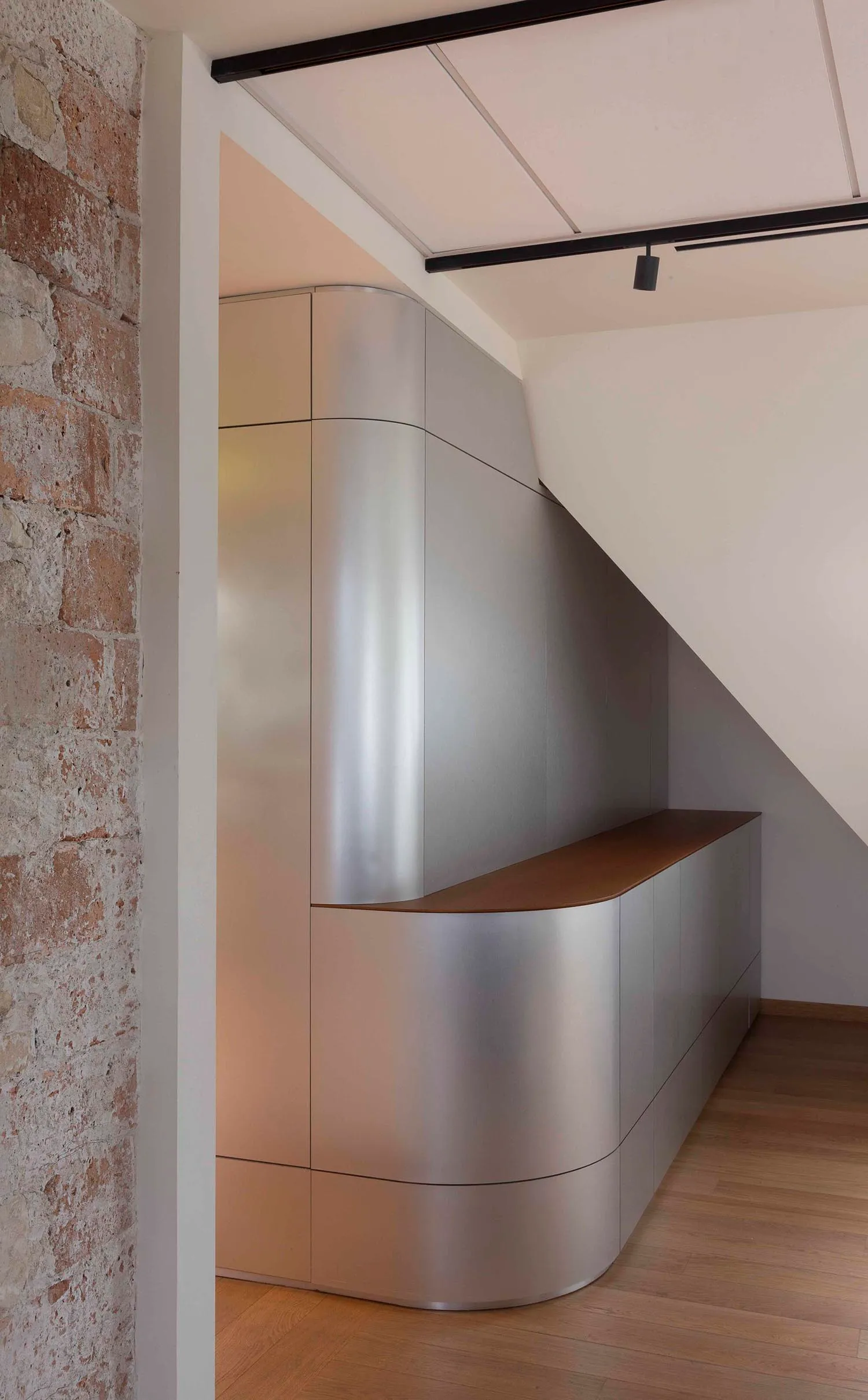 Modern interior design featuring metallic cabinets with sleek, curved lines.