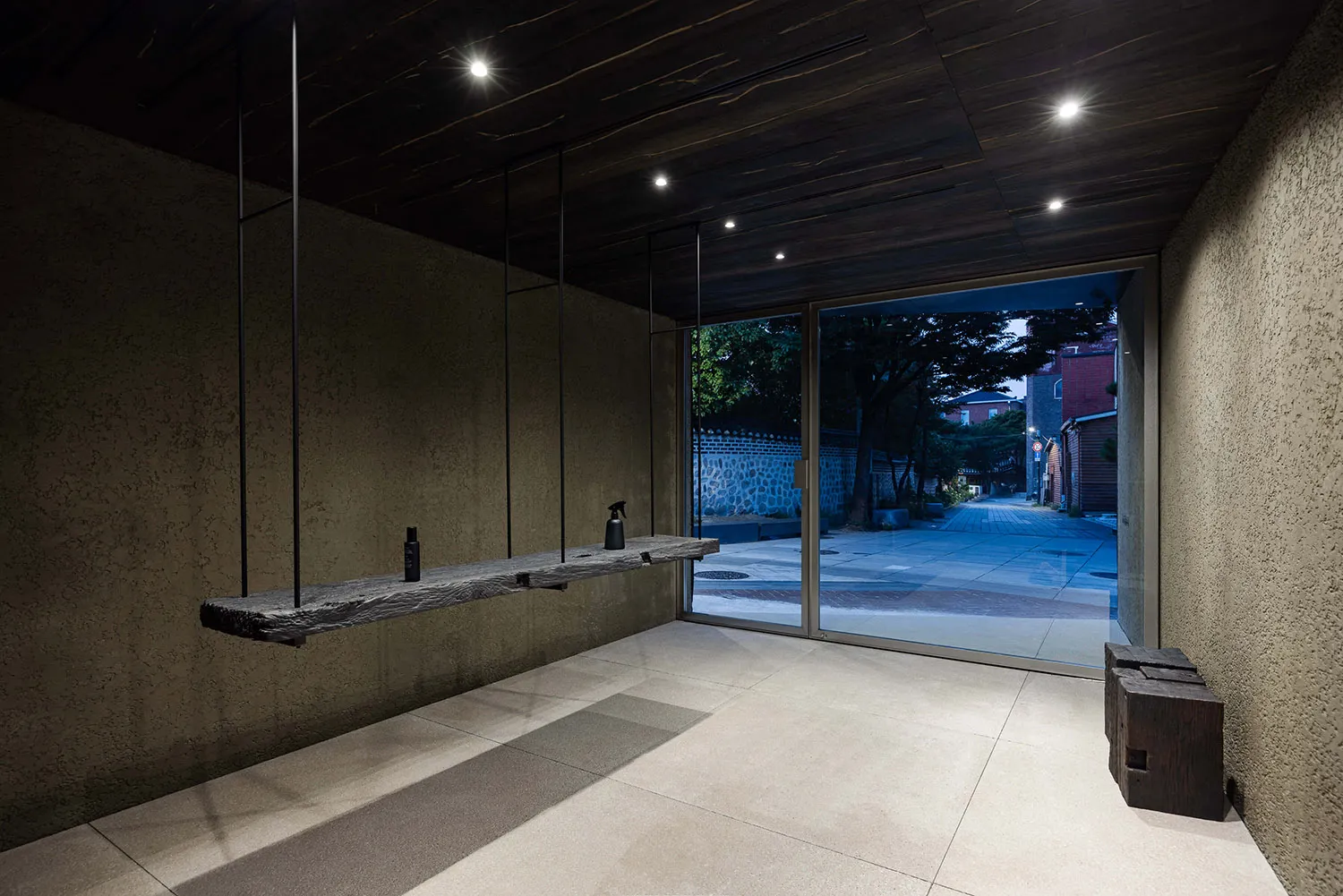 A modern retail storefront with concrete walls and a minimalist design.