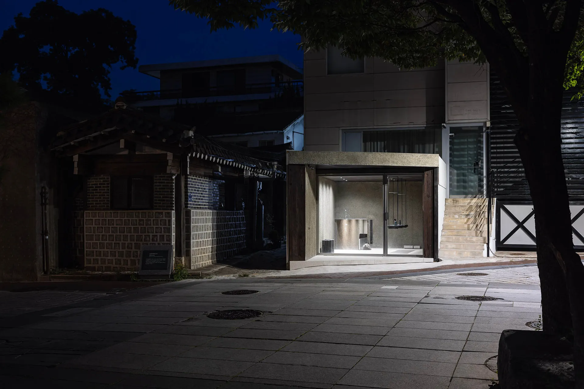 A modern urban architectural design featuring contemporary lighting.