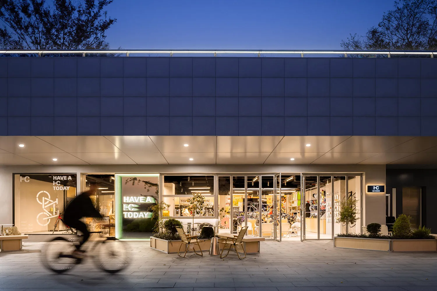 A modern retail storefront featuring a glass window display with bicycles and signage.