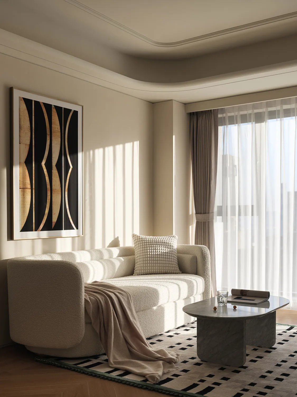 A modern living room featuring a textured fabric sofa, marble coffee table, and sheer curtains allowing soft light to filter