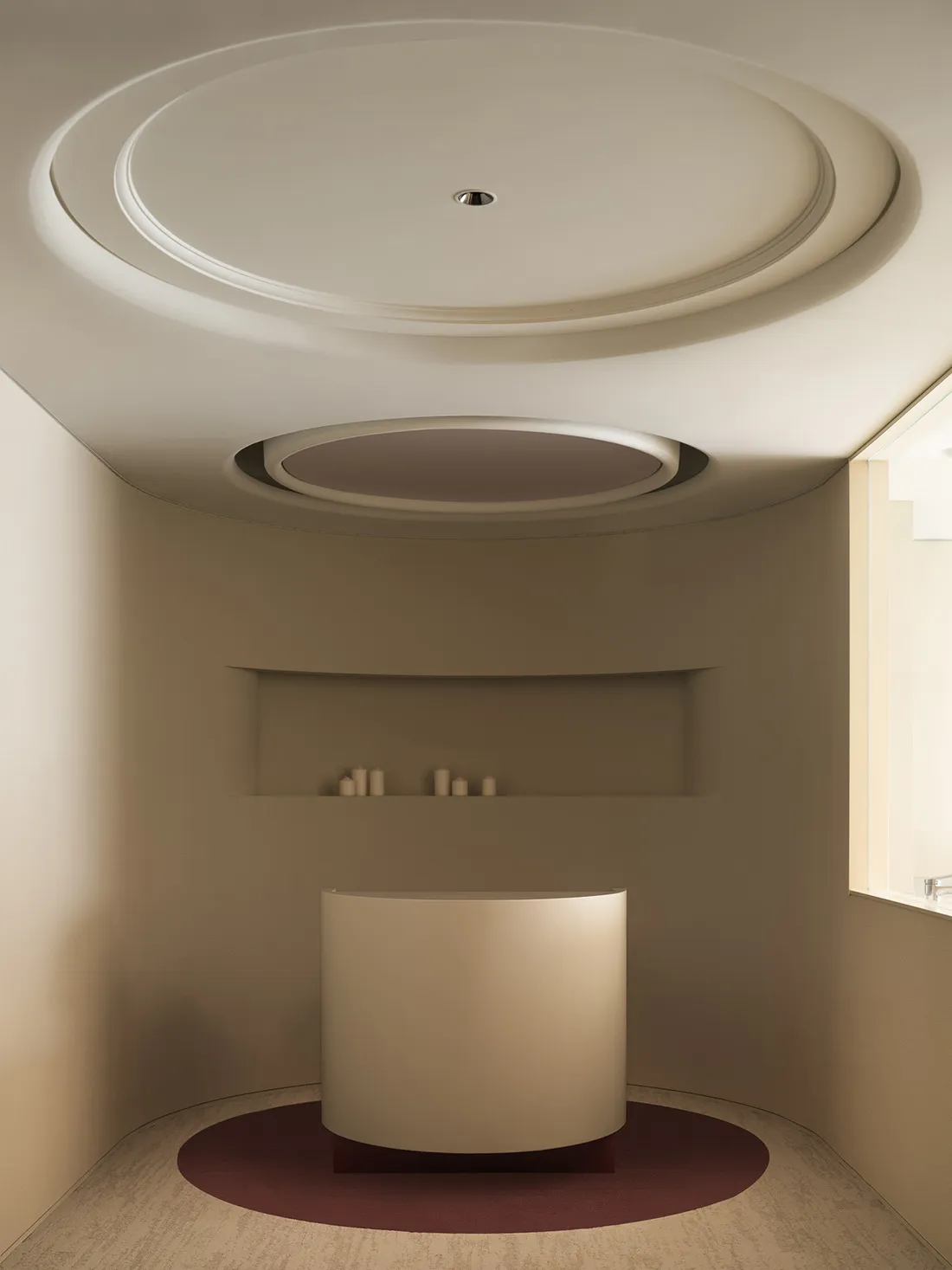 A minimalist bathroom with a luxurious porcelain bathtub and modern design elements.