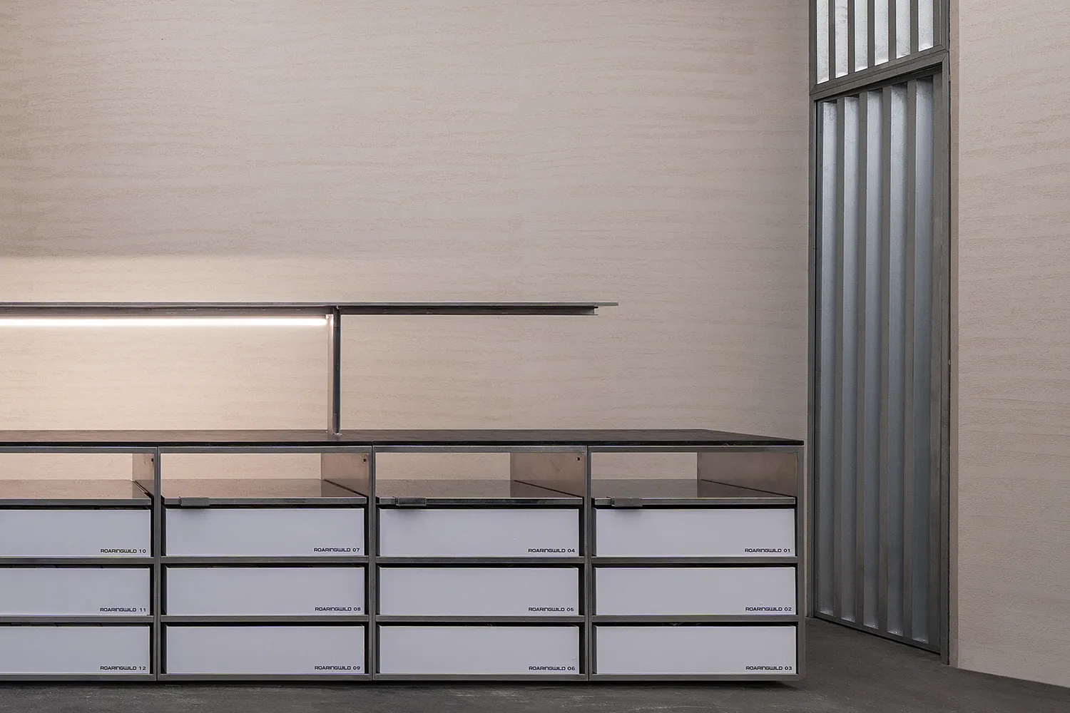 Minimalist furniture with metal drawers and shelves in a modern setting.