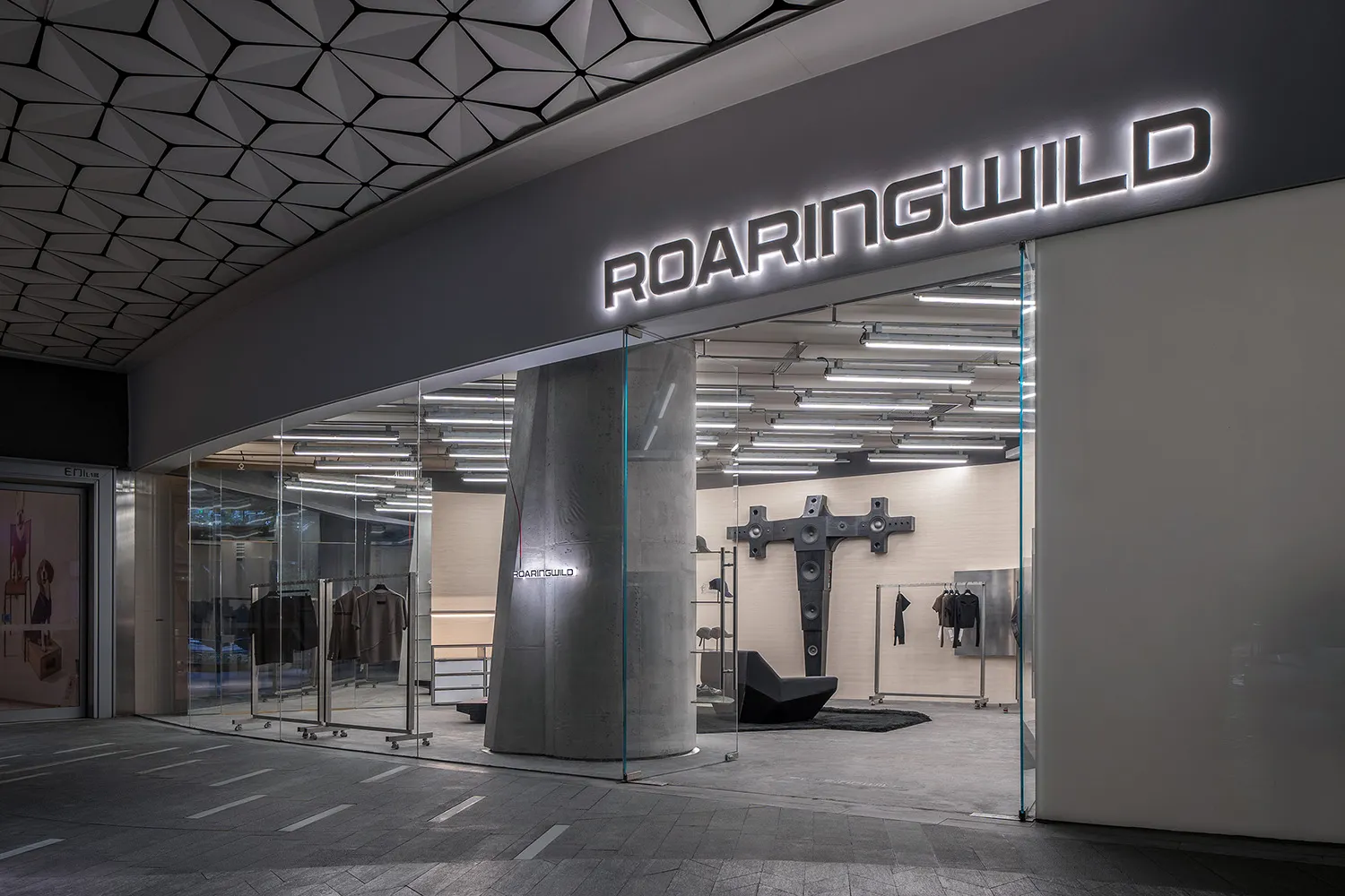 Modern retail storefront featuring concrete and glass materials.