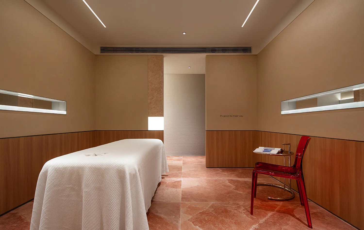 Modern spa room with a white bed on a marble floor
