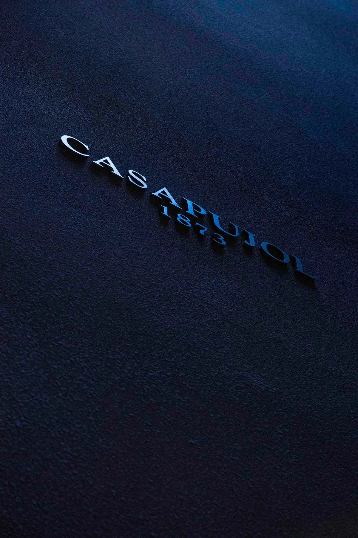 Black Casapujol 1873 alphabet on dark background