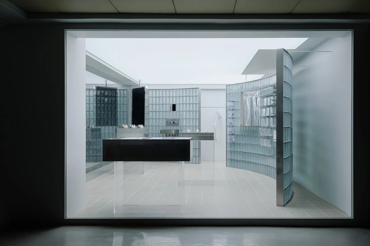 Minimalist retail store interior featuring glass and concrete materials