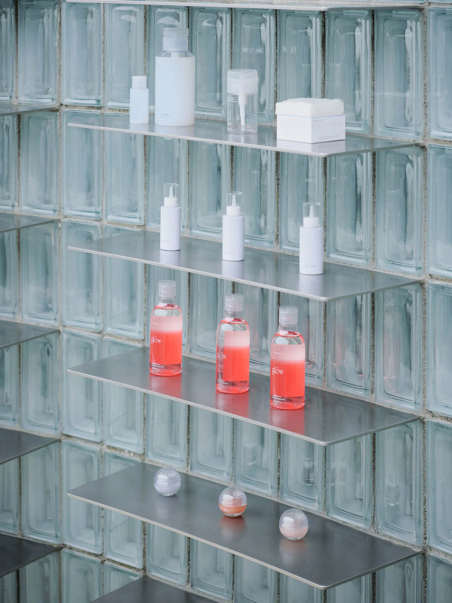 Shelves in a retail environment displaying beauty products in a sleek, modern setting.