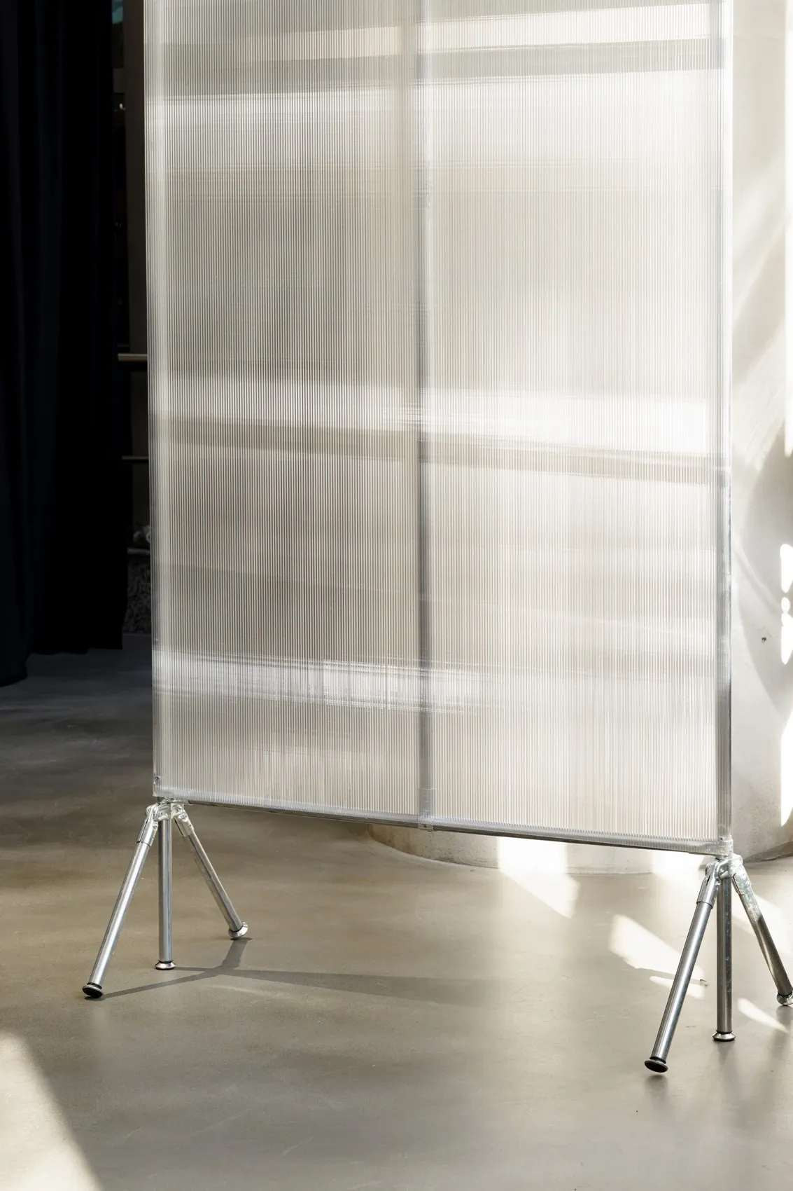 A modern interior design featuring a metal partition screen.