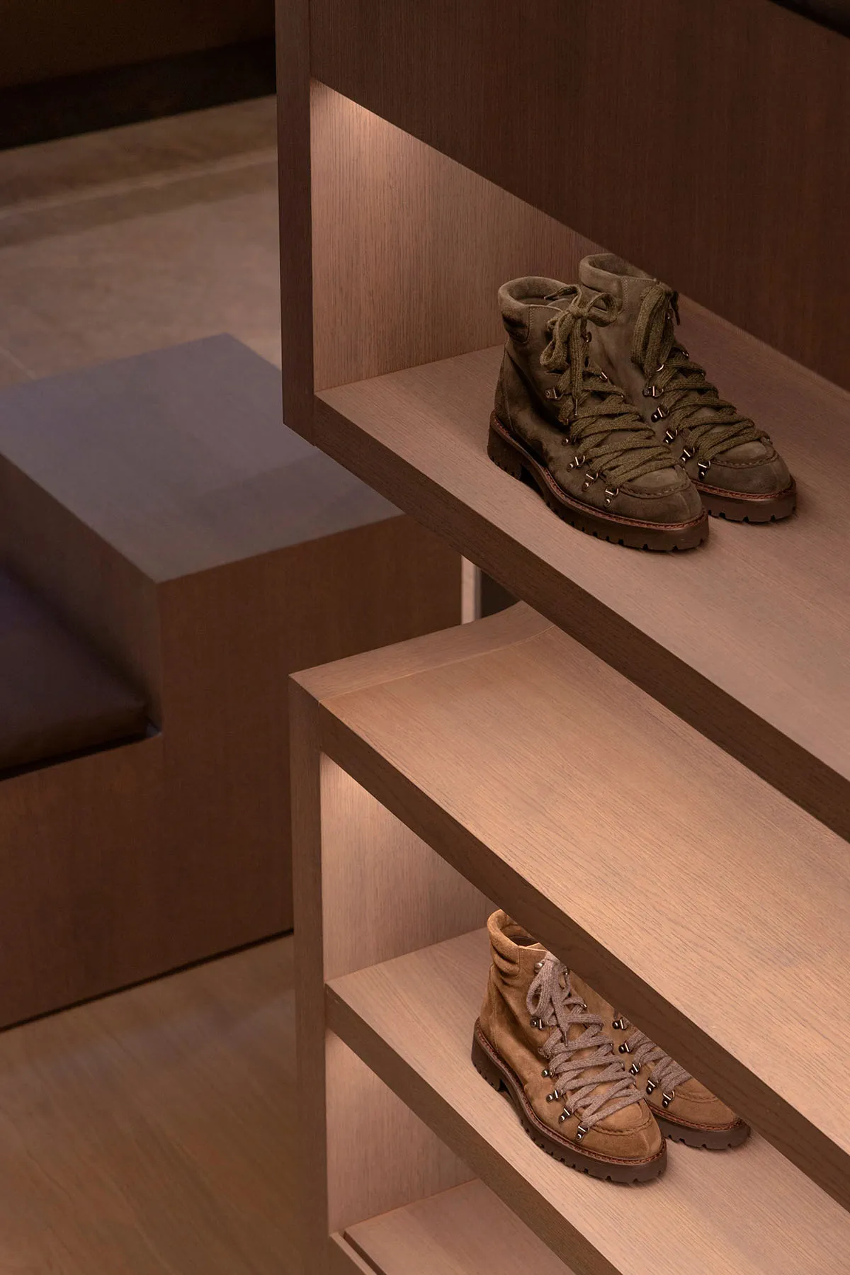Modern, sleek shoe storage solution featuring wooden shelves with built-in lighting.