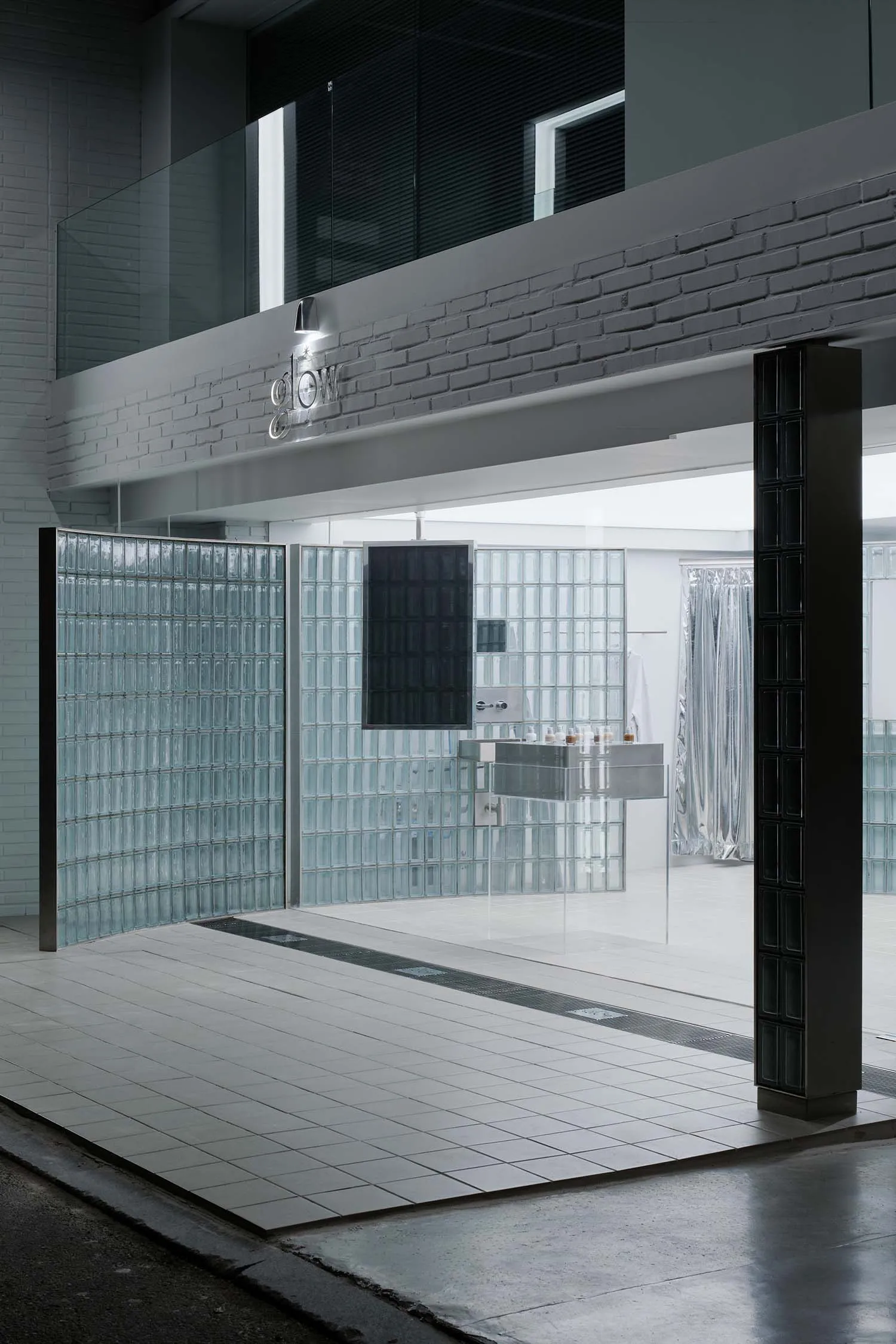 Modern spa interior with glass walls and minimalist design elements.