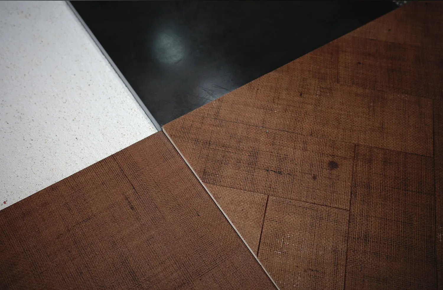 Different patterns of wooden floor tiles displayed on a floor.