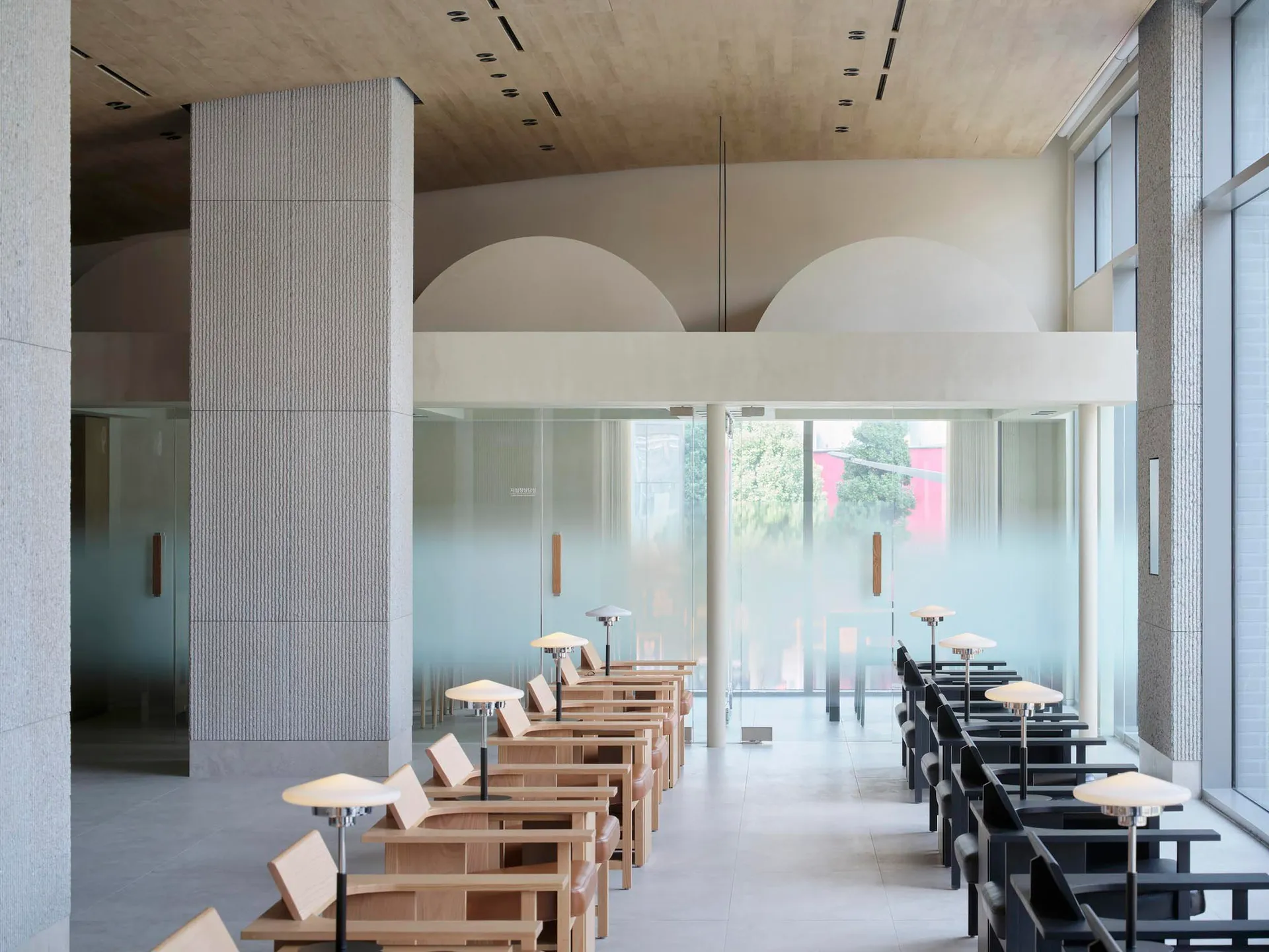 Modern, minimalist coffee shop interior with glass and wood materials.