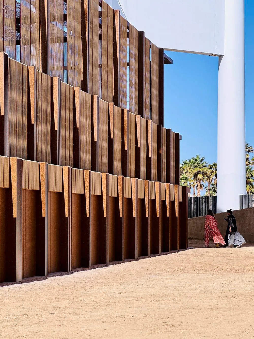 Modern architecture with brick exterior and sandy ground