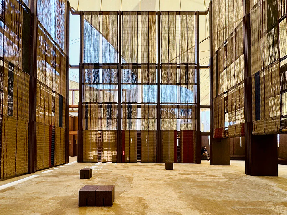 A spacious, modern library with textile partitions and wooden flooring.
