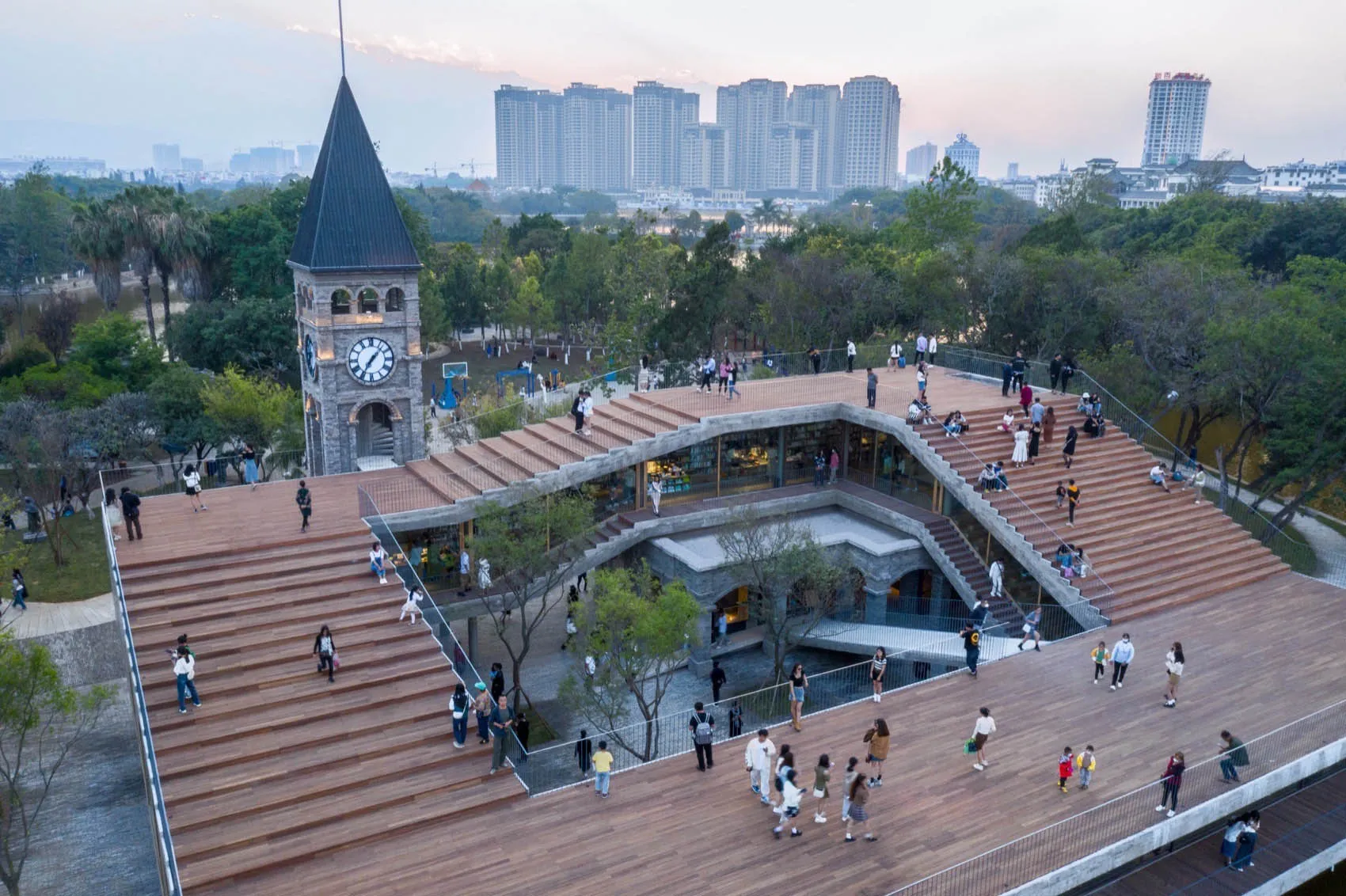 A bustling urban park featuring modern architecture and lush greenery.