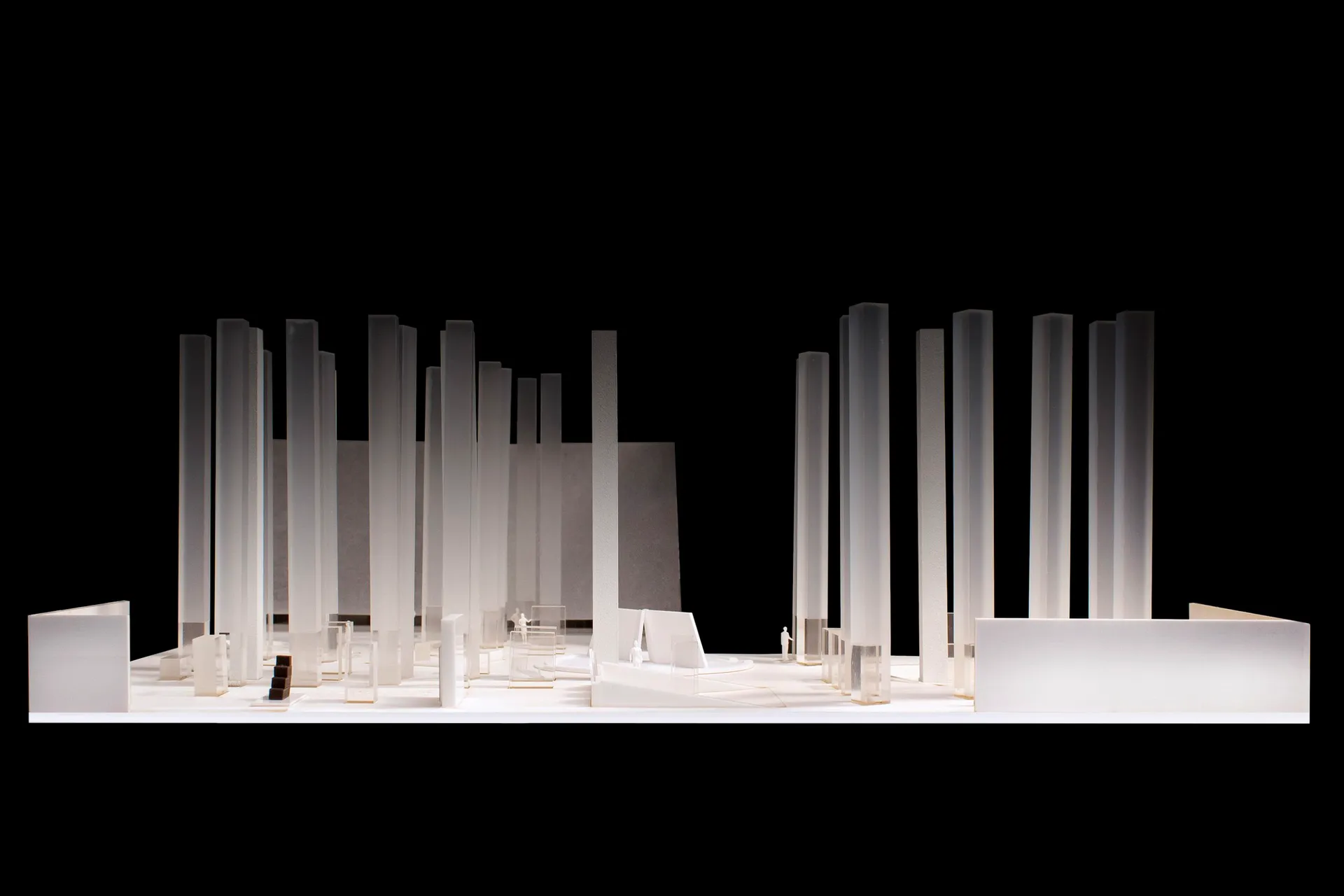 A model of a modern architectural design featuring tall columns made of glass, metal, and concrete materials.