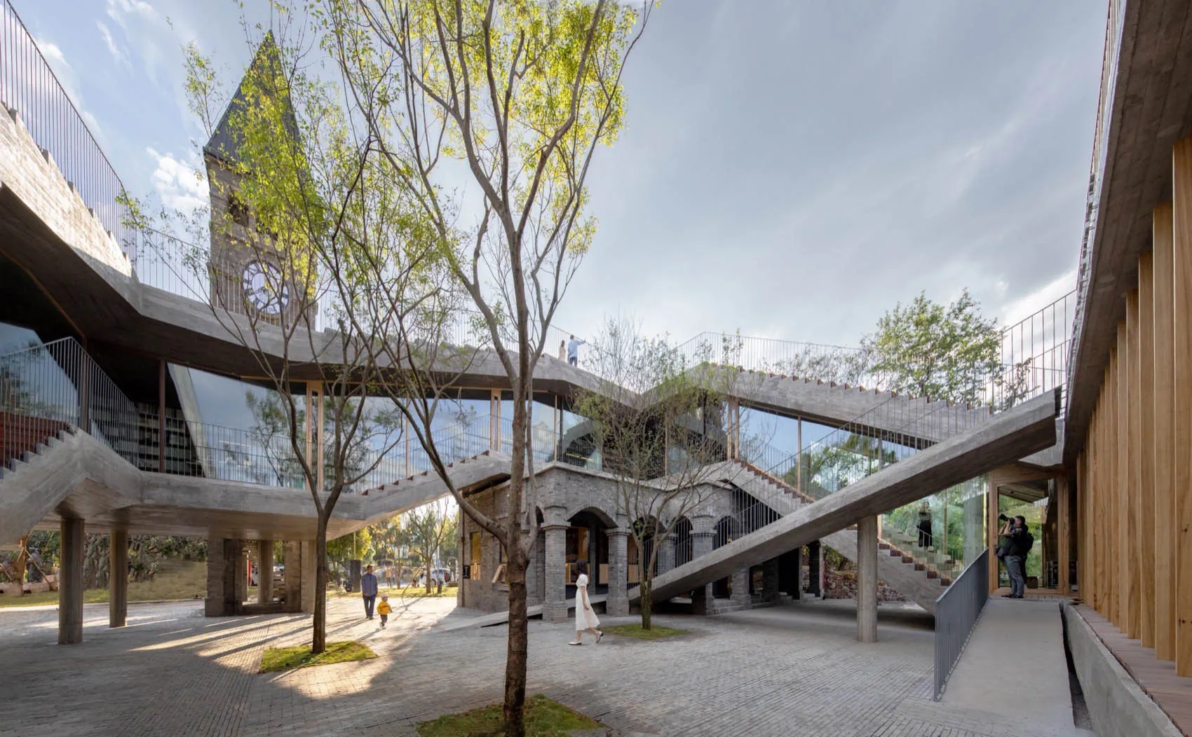 Large, modern building with concrete, glass, and wooden elements