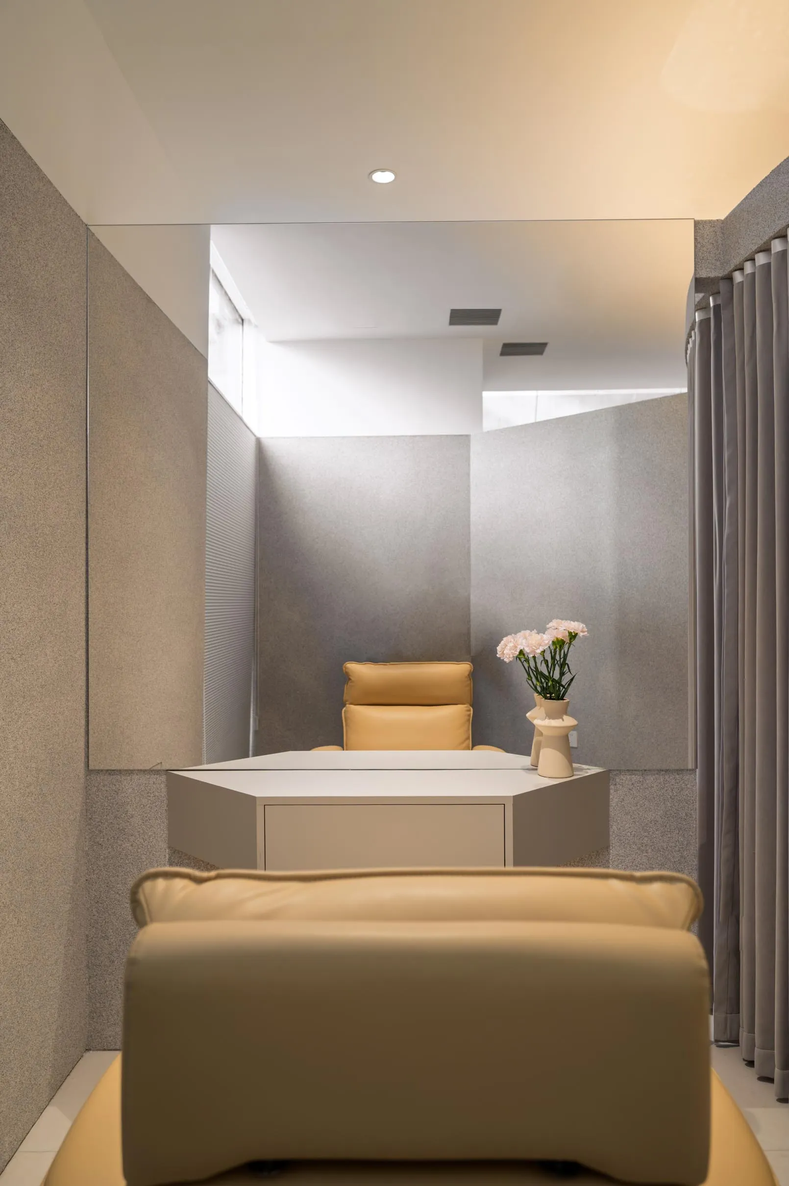 A minimalist office space featuring concrete and leather materials.
