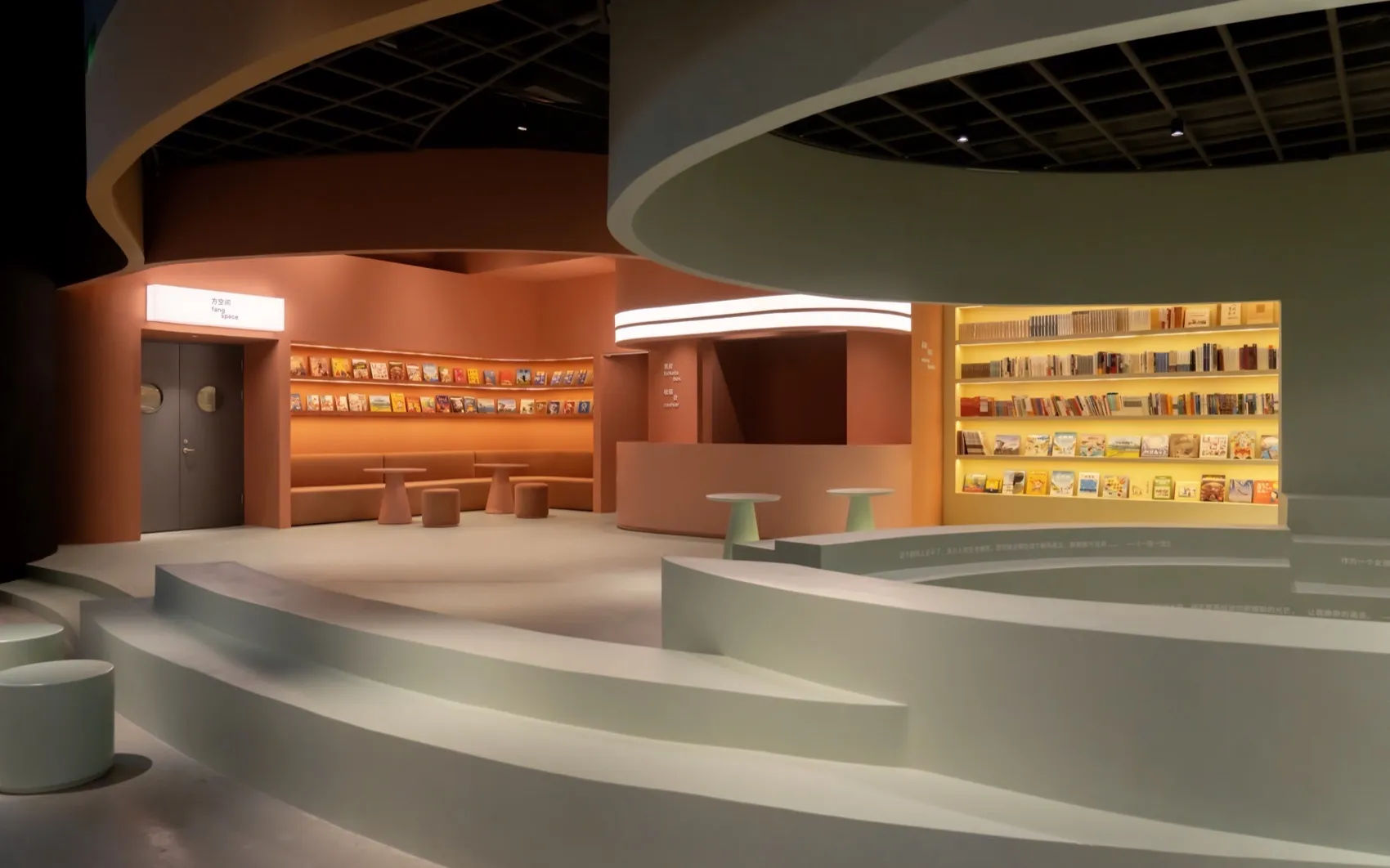 Modern exhibition space with neutral color palette and concrete architectural elements.