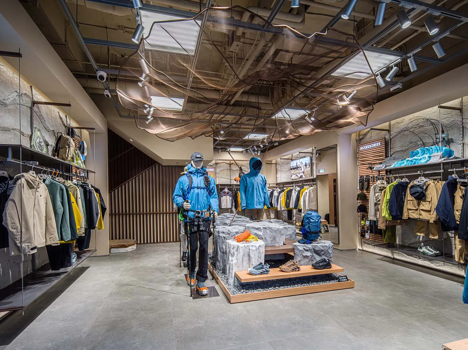 Modern retail store interior featuring clothing racks, mannequins, and shoes on display.