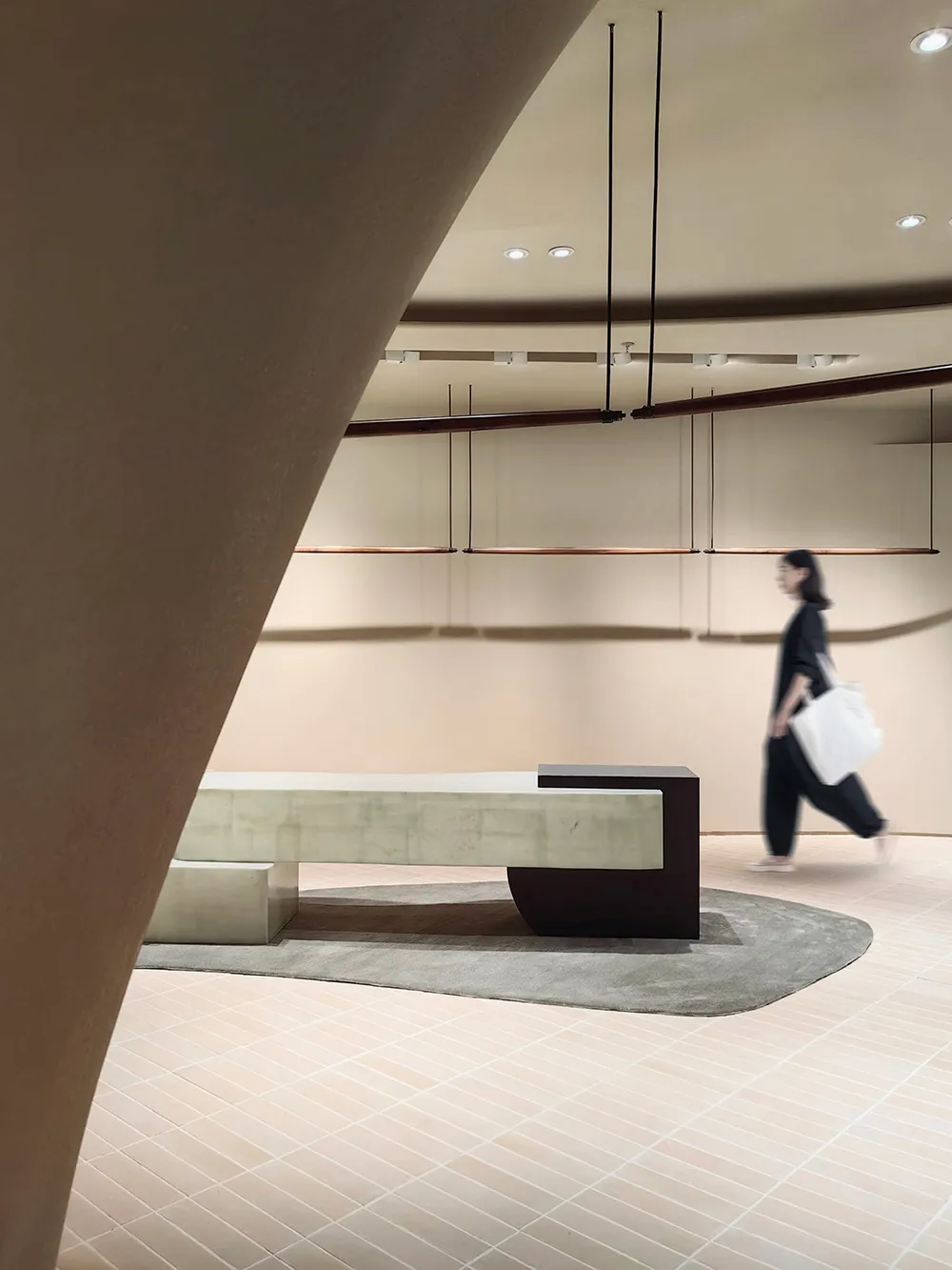 A modern lobby featuring concrete materials and a sleek, minimalist design.