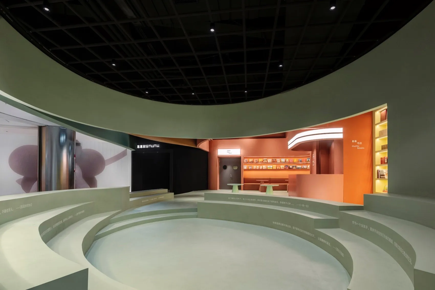 A modern design interior space with concrete walls, circular seating areas, and an orange-red lighting scheme.