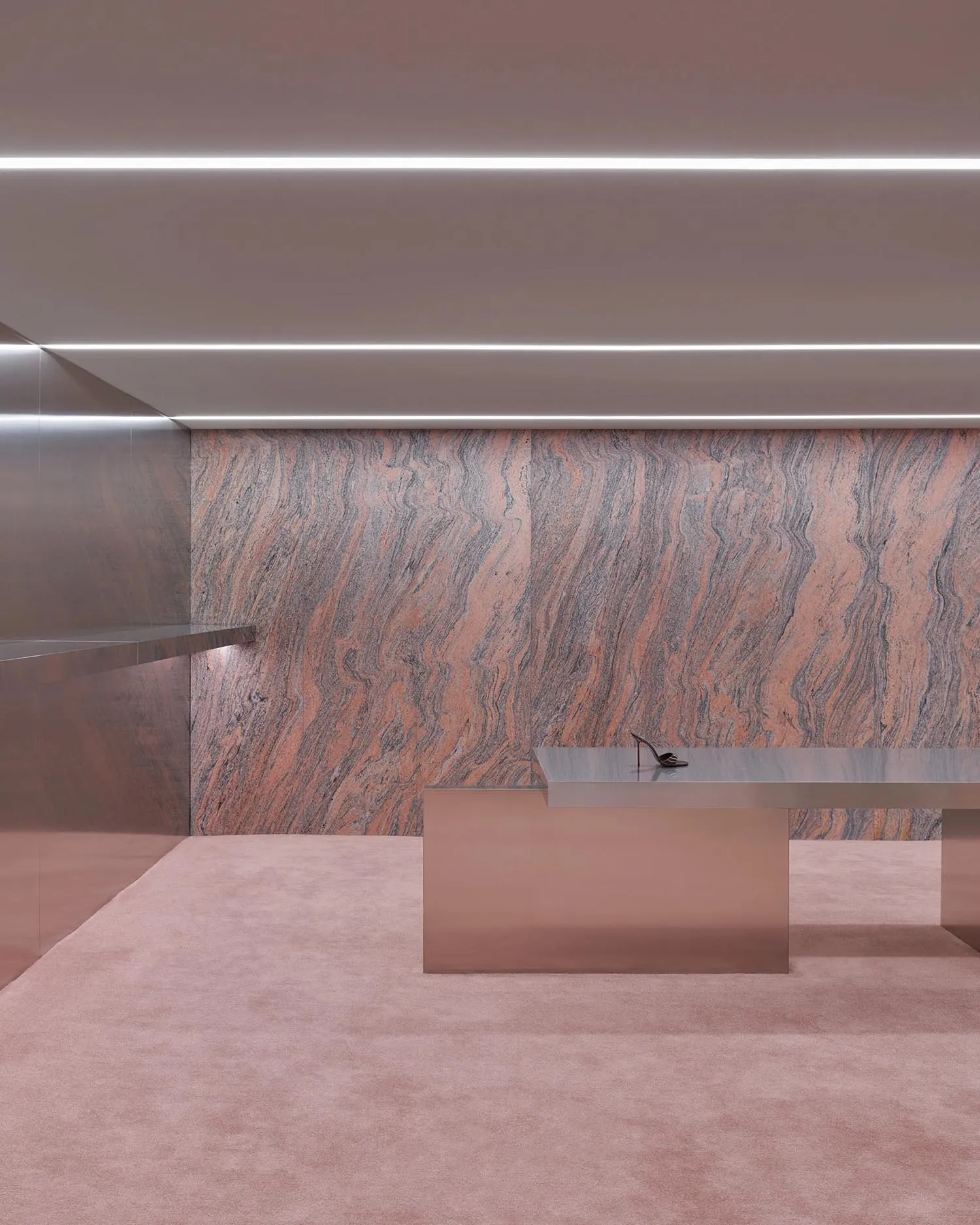 Modern office space with marble table and sleek design elements.