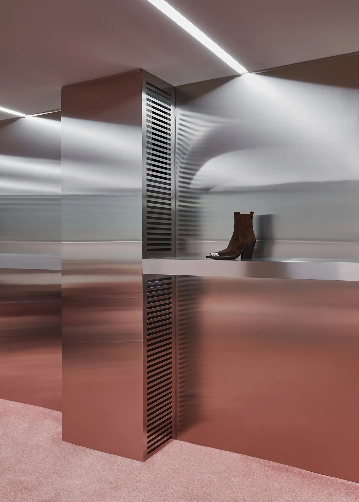 Modern retail storefront featuring metallic materials and minimalist design elements.