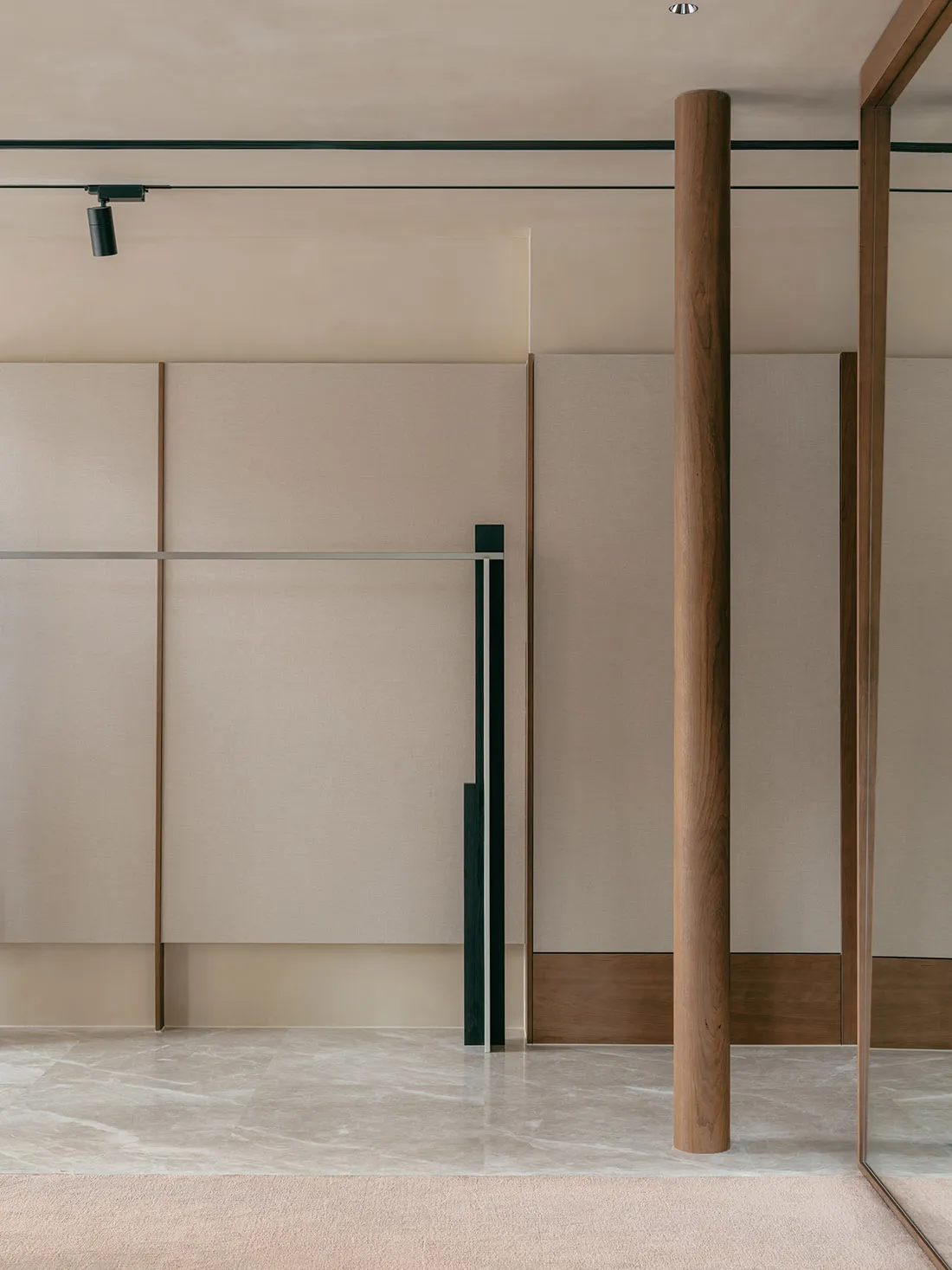 A minimalist interior space featuring modern lighting fixtures and furniture.
