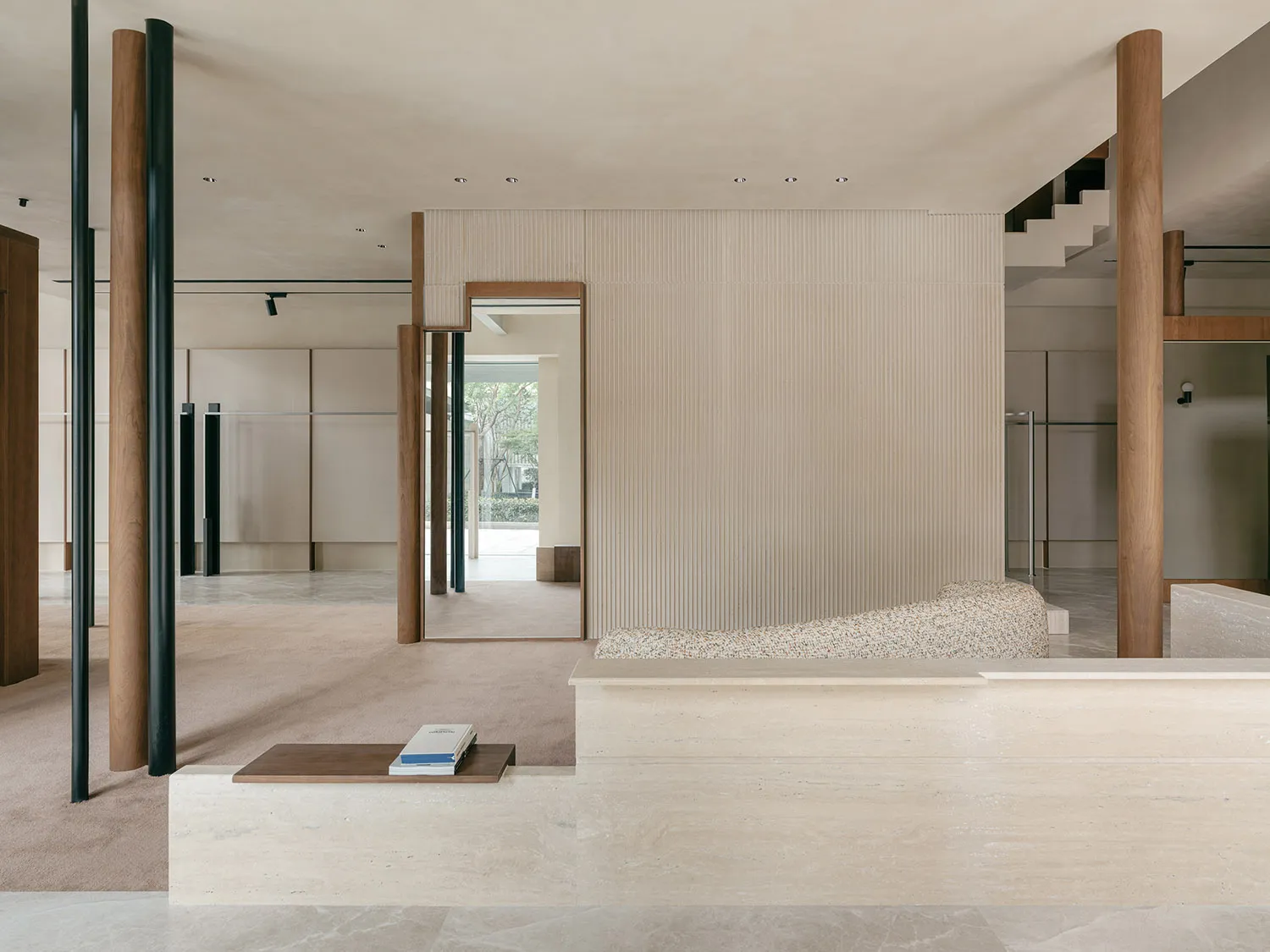 A minimalist living space featuring concrete walls and furniture.