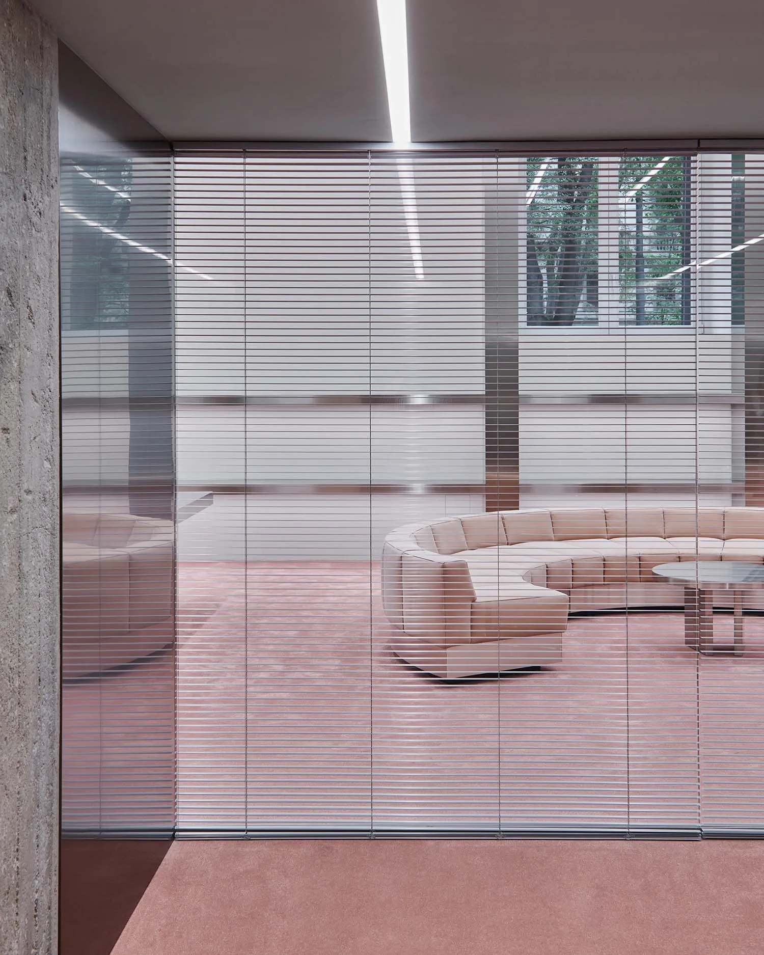 Modern minimalist retail space featuring glass walls, concrete flooring, and metal accents.