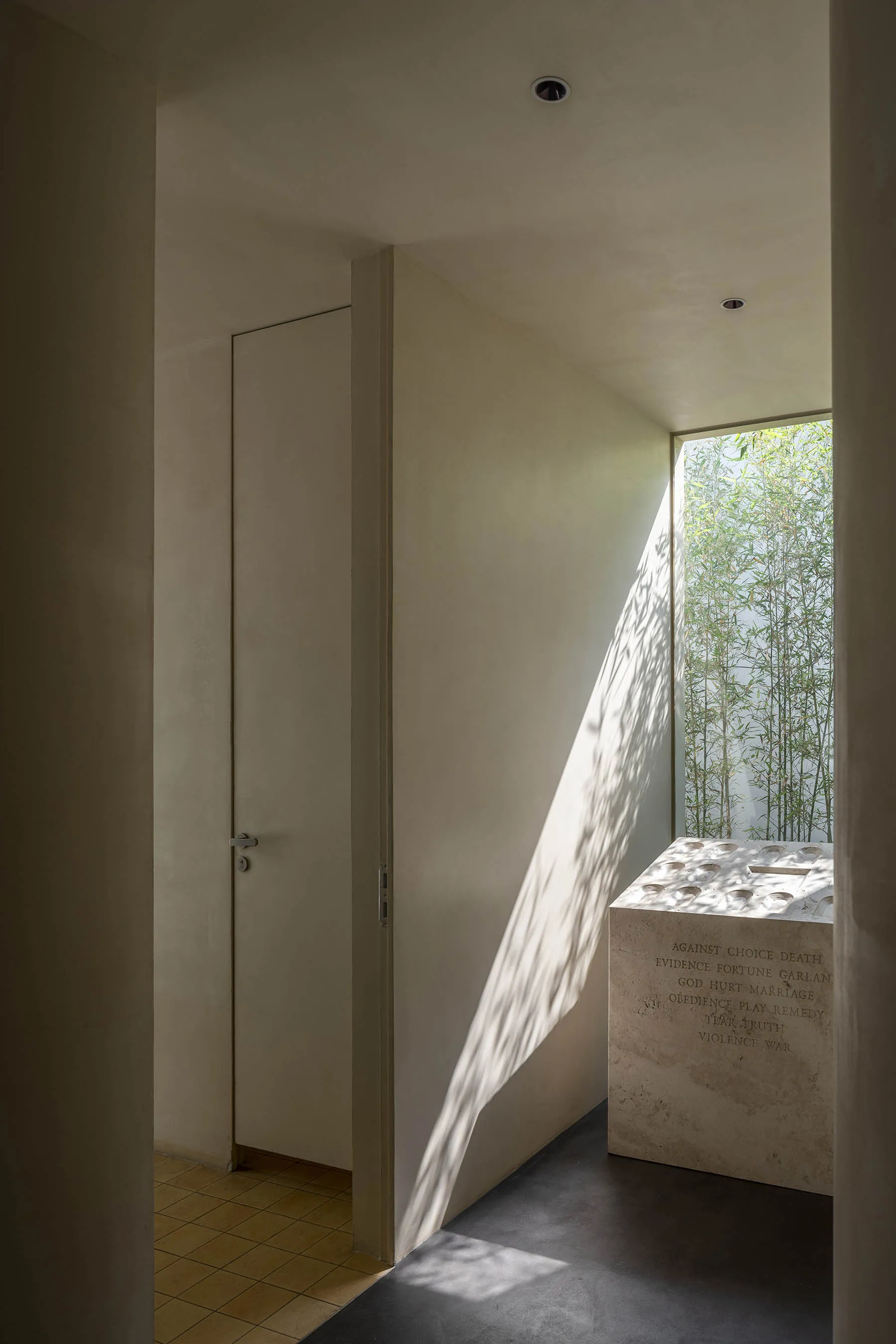 A modern interior space featuring concrete and glass materials.
