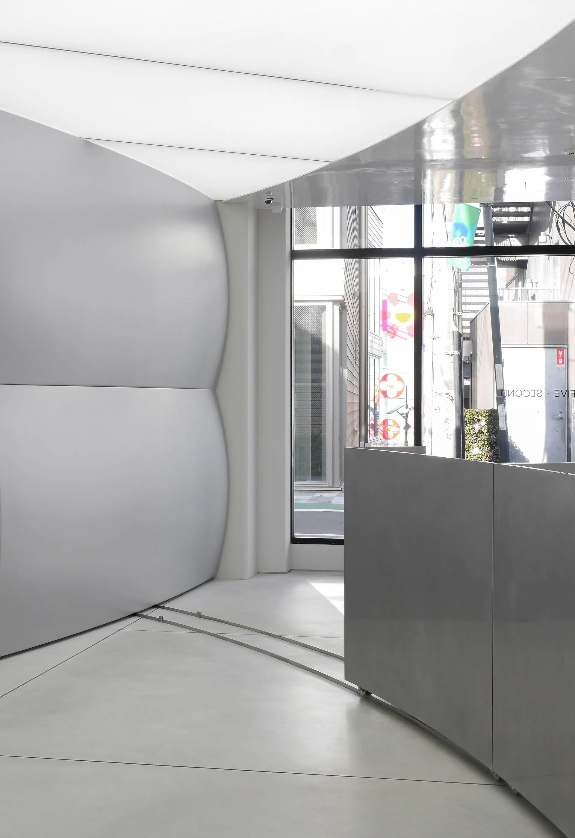 A minimalist interior space featuring metallic balustrades and clean lines.