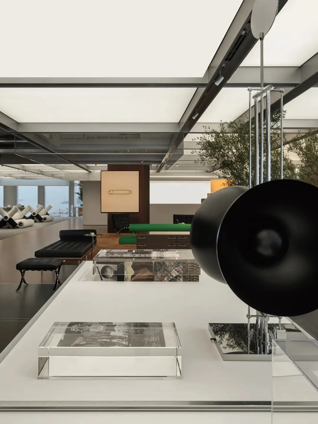 Modern living room featuring sleek, metallic furniture and transparent glass decor.