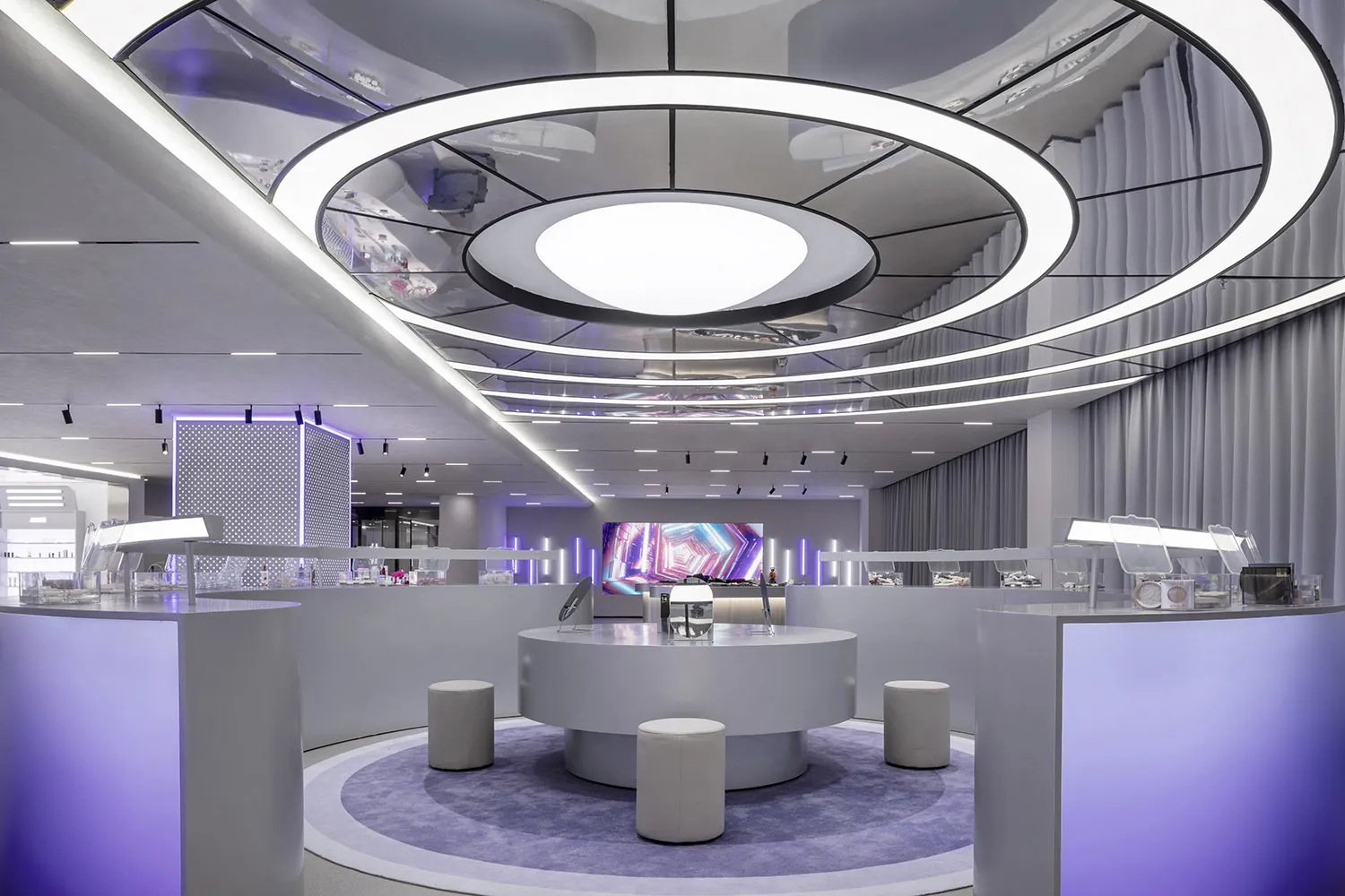 A modern retail store interior with glass displays, metallic accents, and fabric curtains.