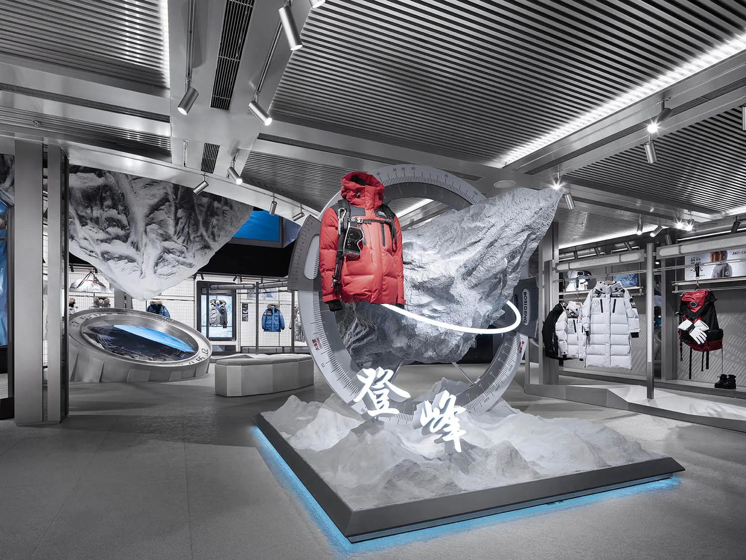 Fashion retail display featuring a red jacket mounted on a white mountain, surrounded by rock formations and a blue backgroun