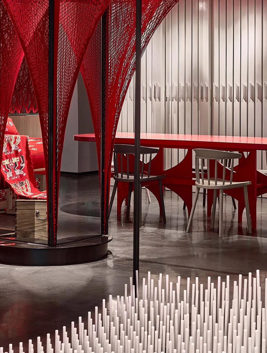 Modern, industrial-style restaurant interior with metallic walls and tables
