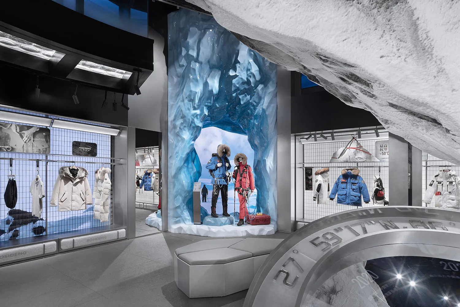 An ice-themed fashion retail store display featuring mannequins dressed in waterproof clothing.